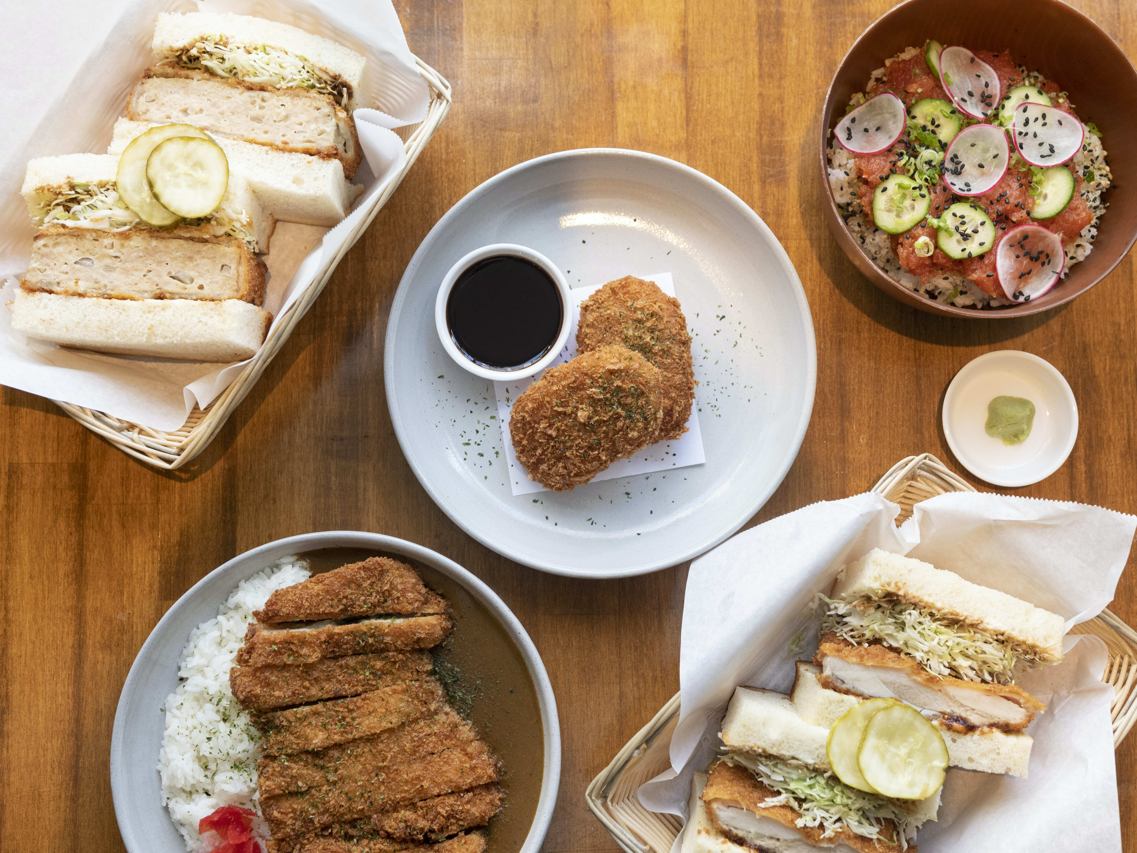 A spread of katsu curry, a katsu sandwich, and croquettes at Cafe Okawari