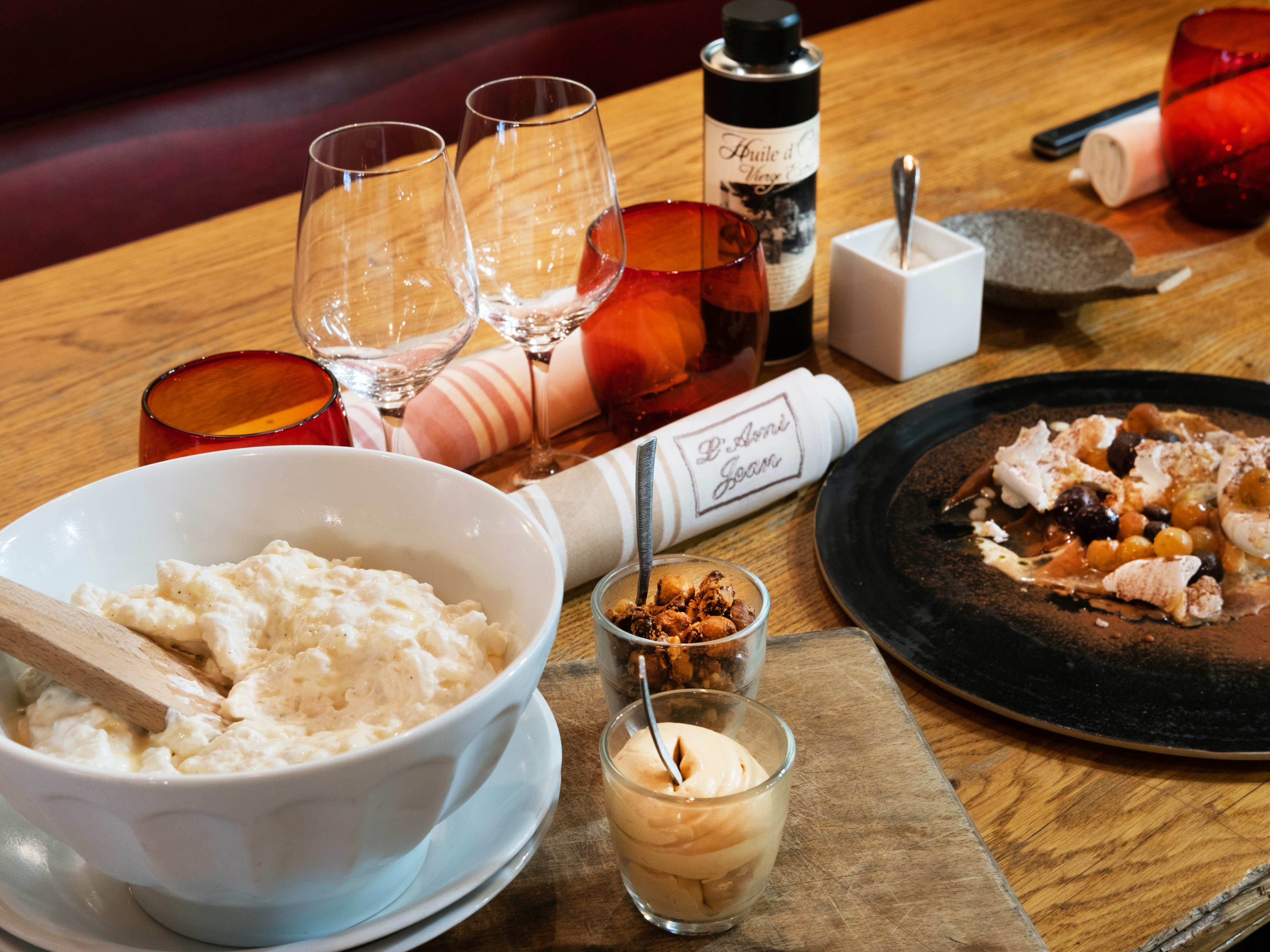 Rice pudding and wine glasses on table at L'Ami Jean