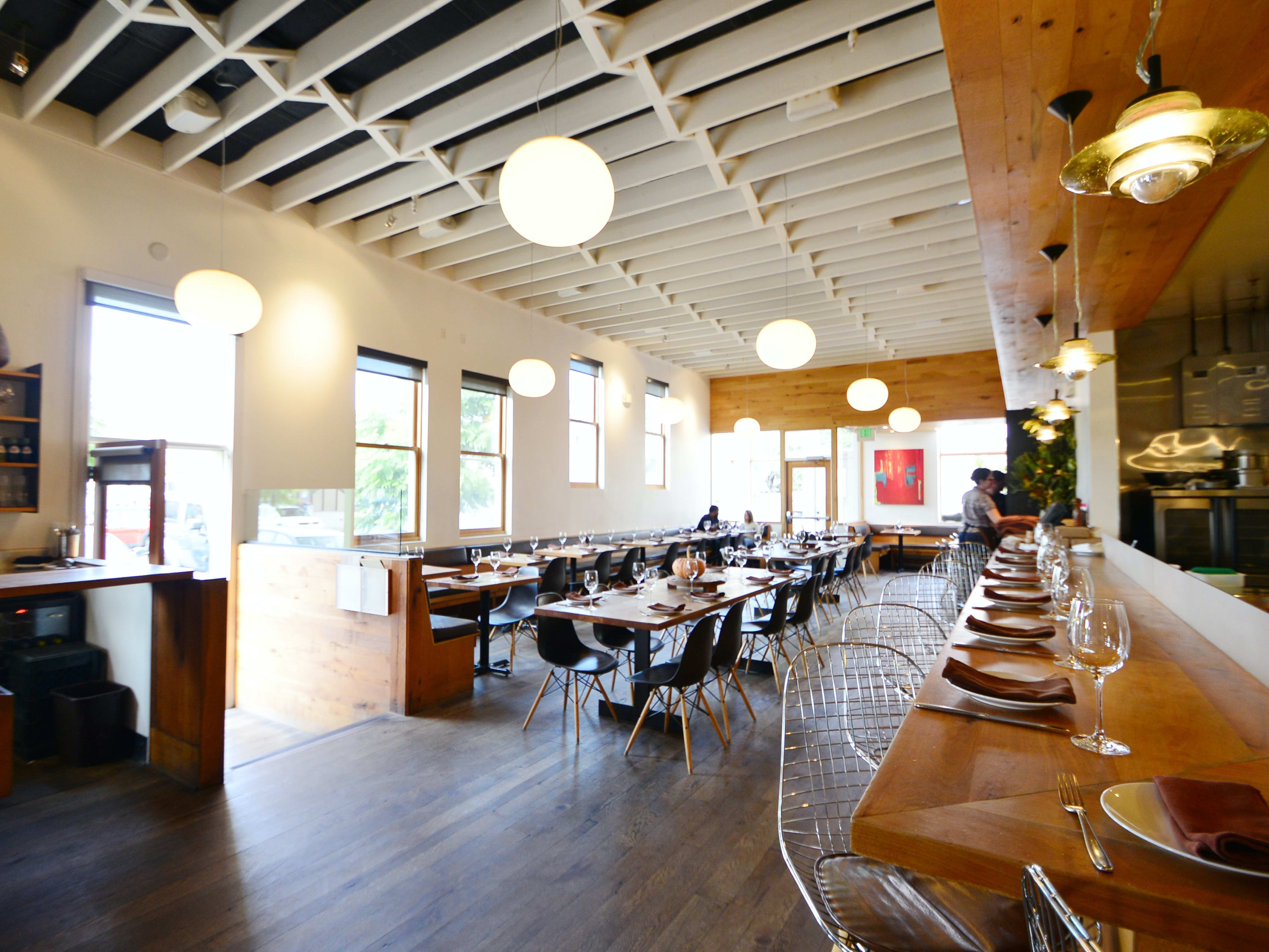 light filled interior with bar seating and tables