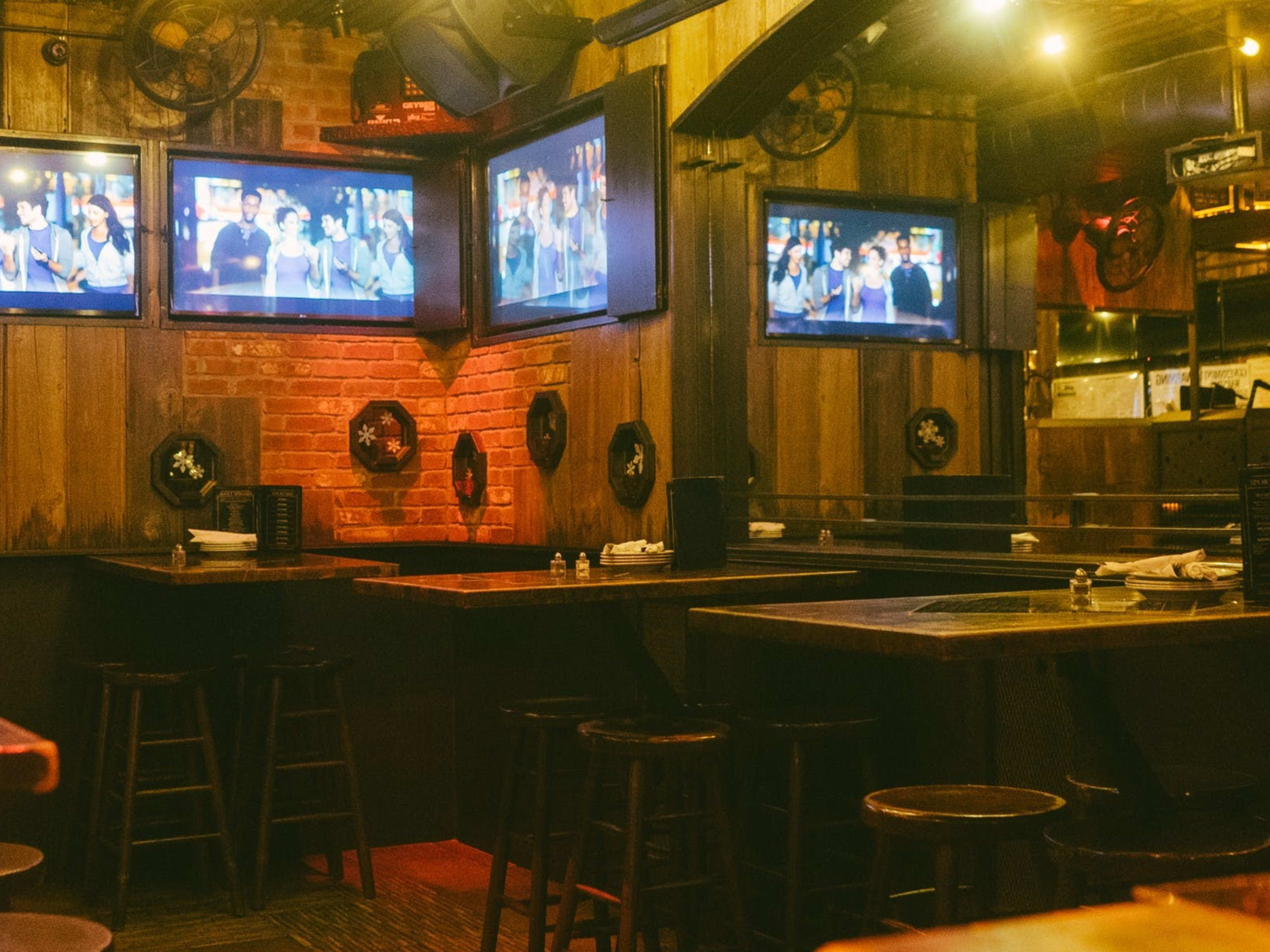 A dark sports bar with TVs.