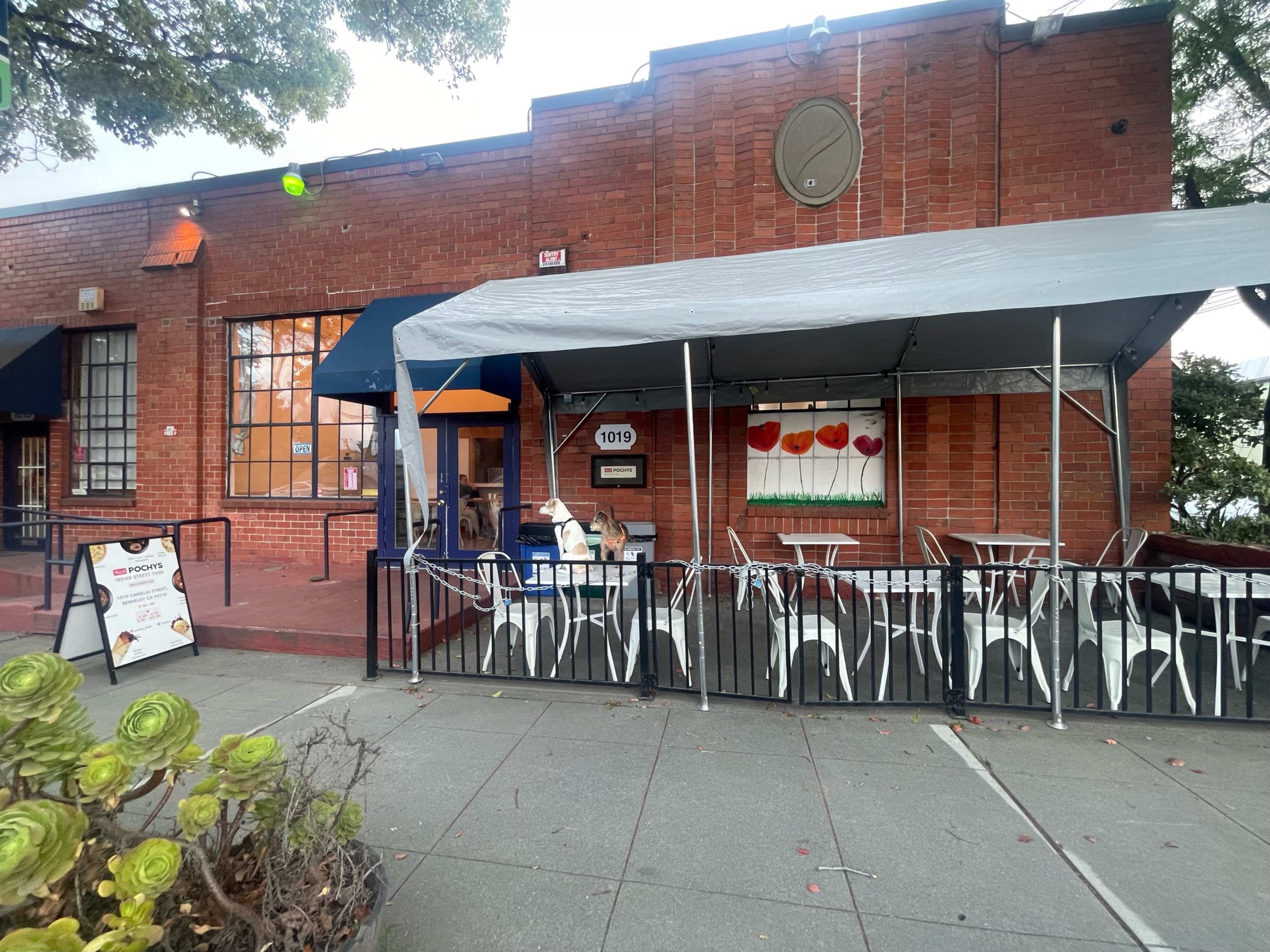 brick exterior of restaurant with covered sidewalk patio