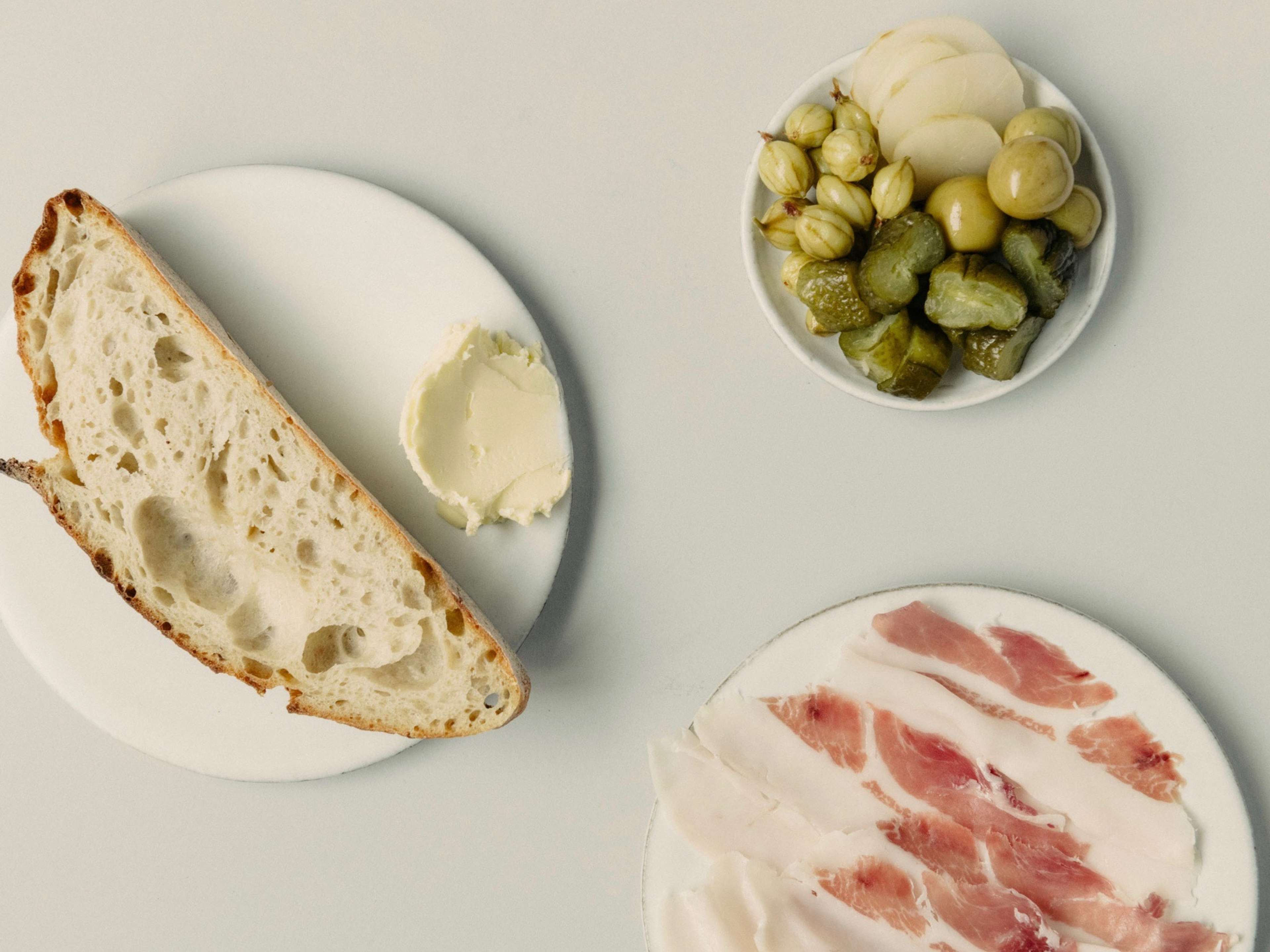 Spread of charcuterie, olives, and bread at Otto