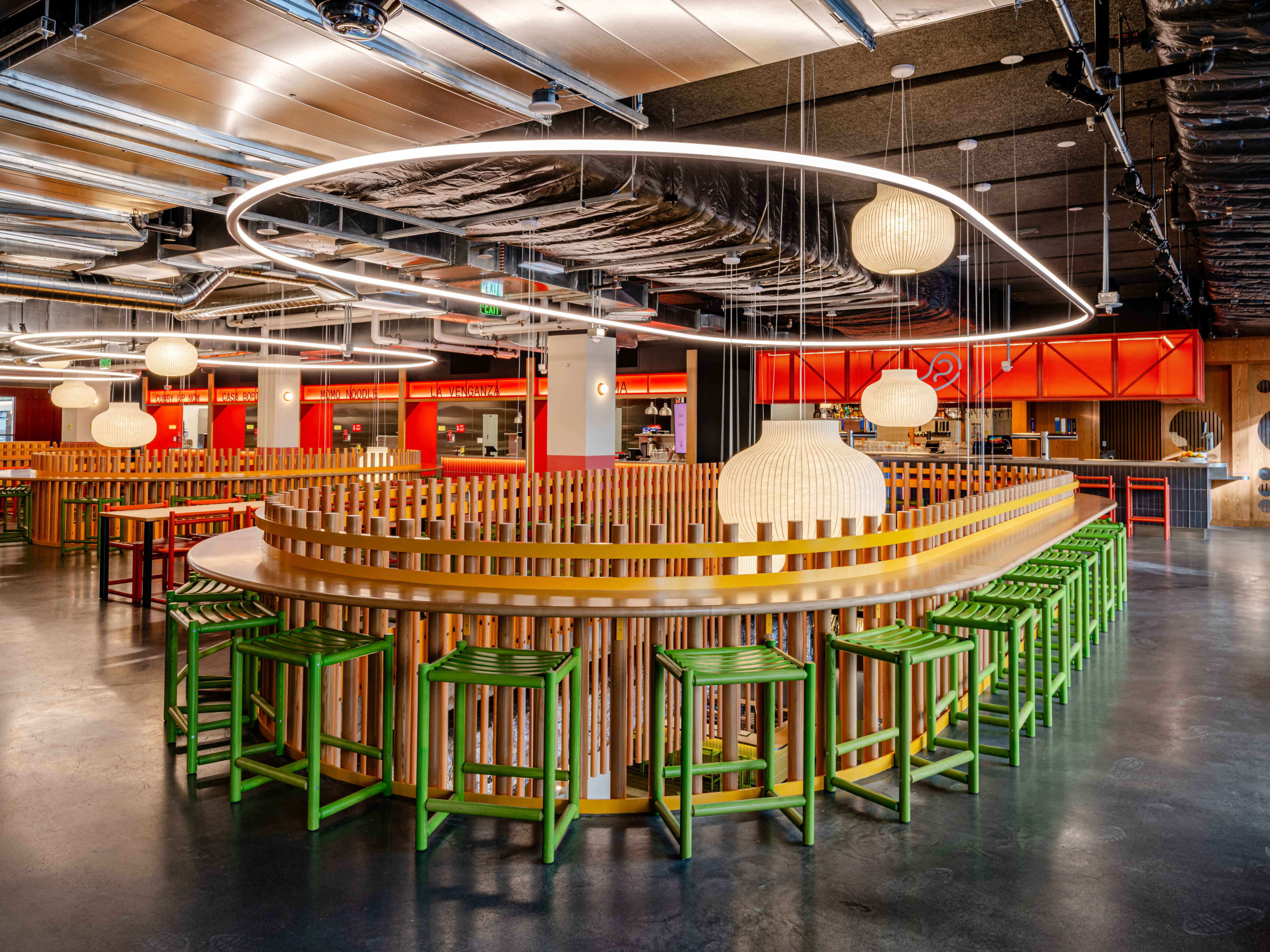 Green chairs and hanging lamps at Saluhall in SF.