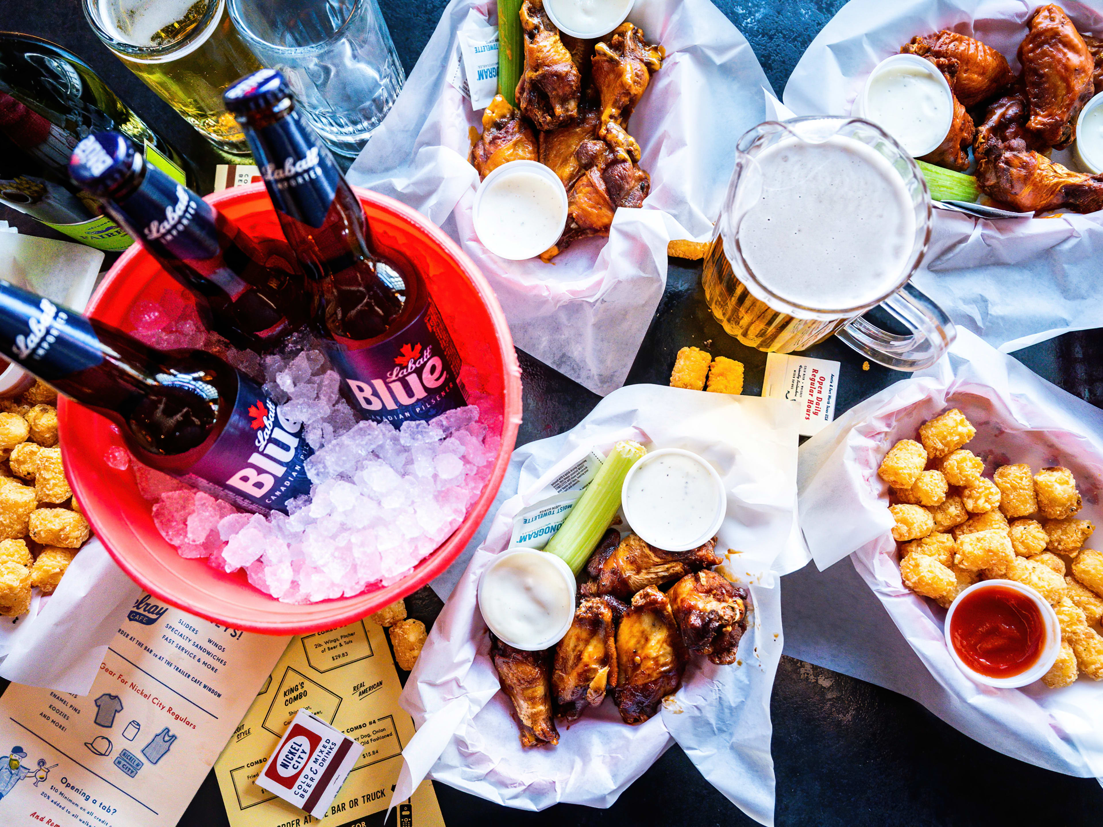 wings, three beers in a bucket of ice, and tater tots