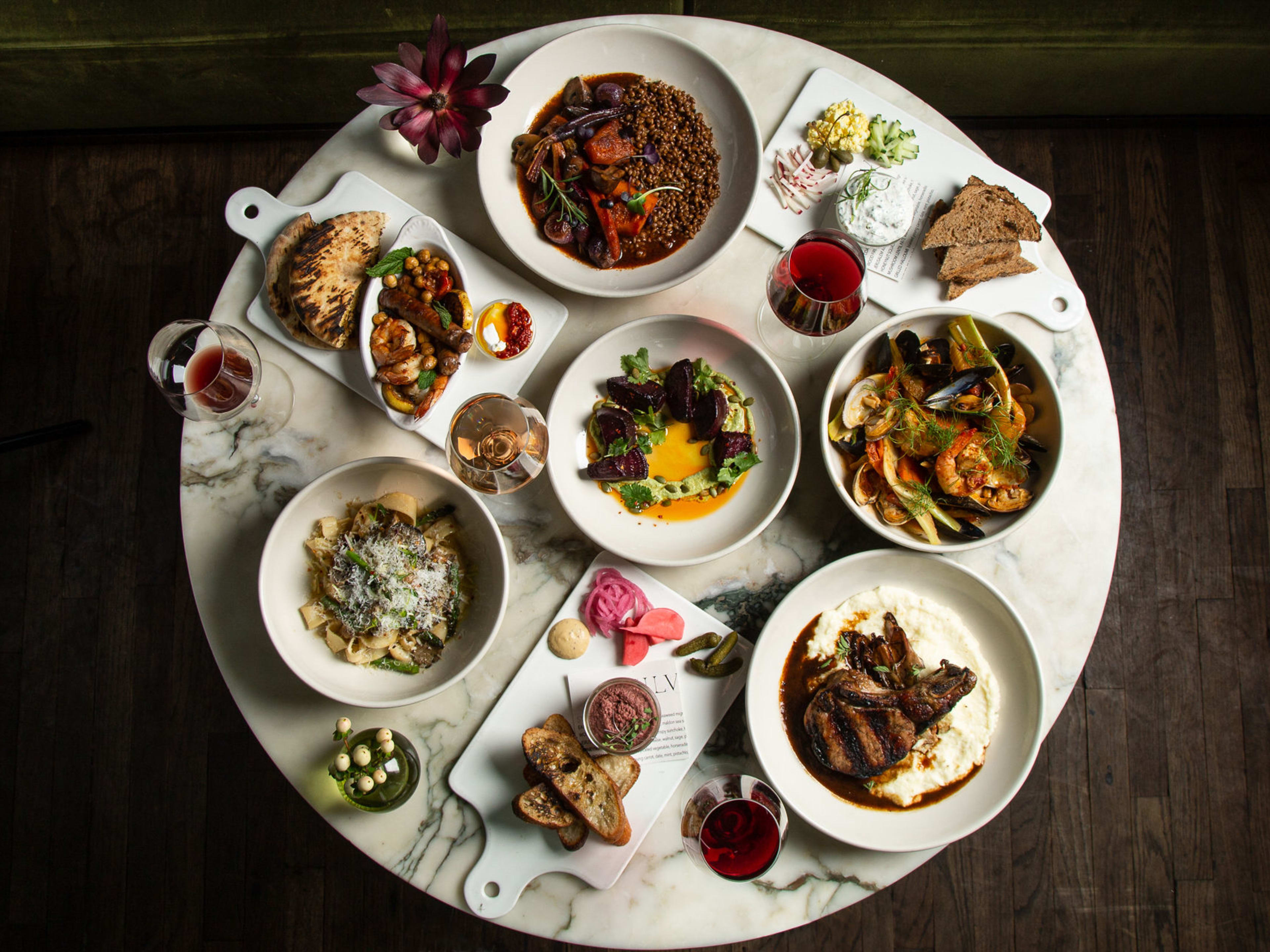 Silvia's dishes including steak, beet salad, bread, and pasta.