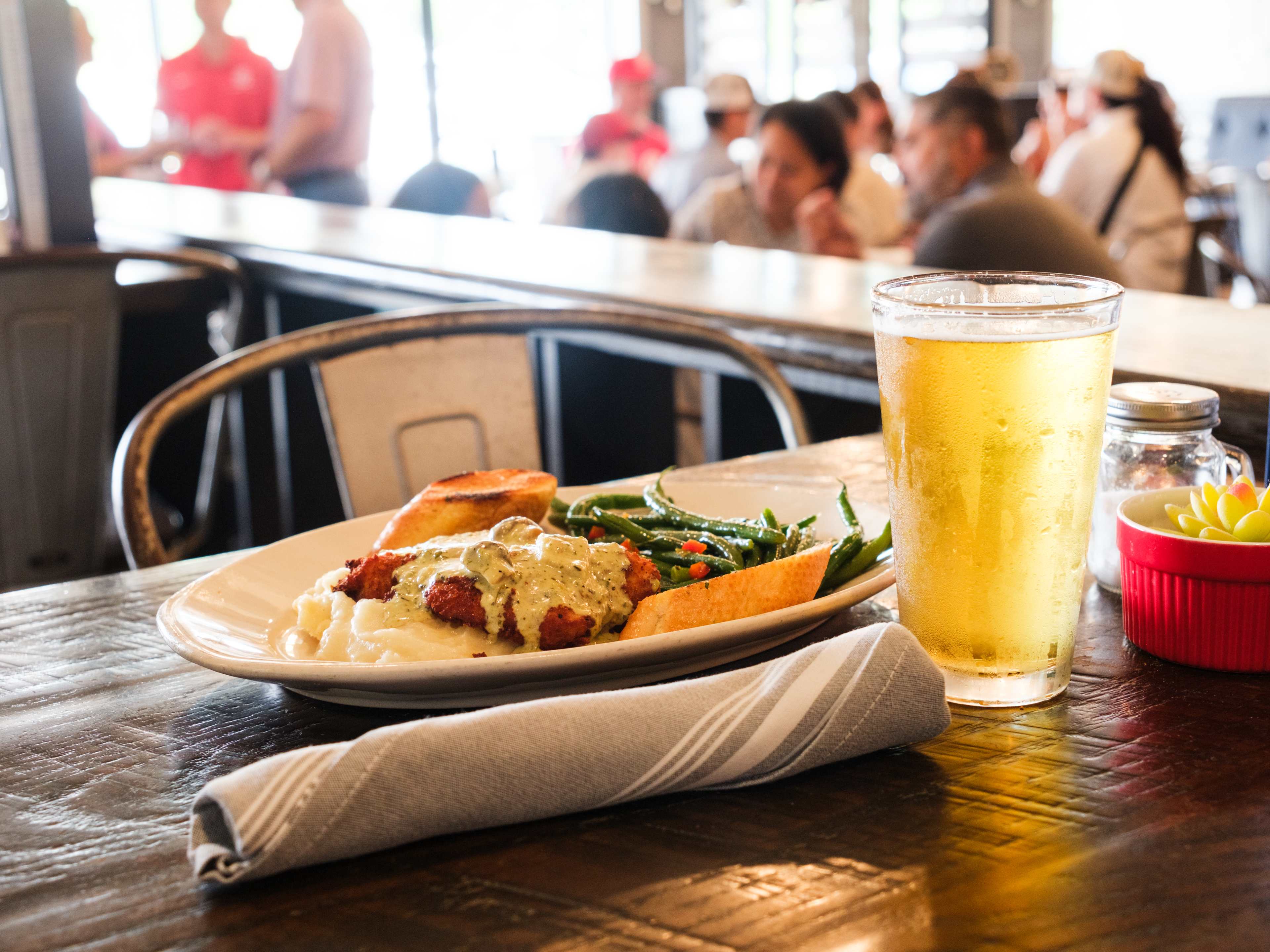 The Southern chicken dish and a beer on a table at The ‘401 Table & Tap.