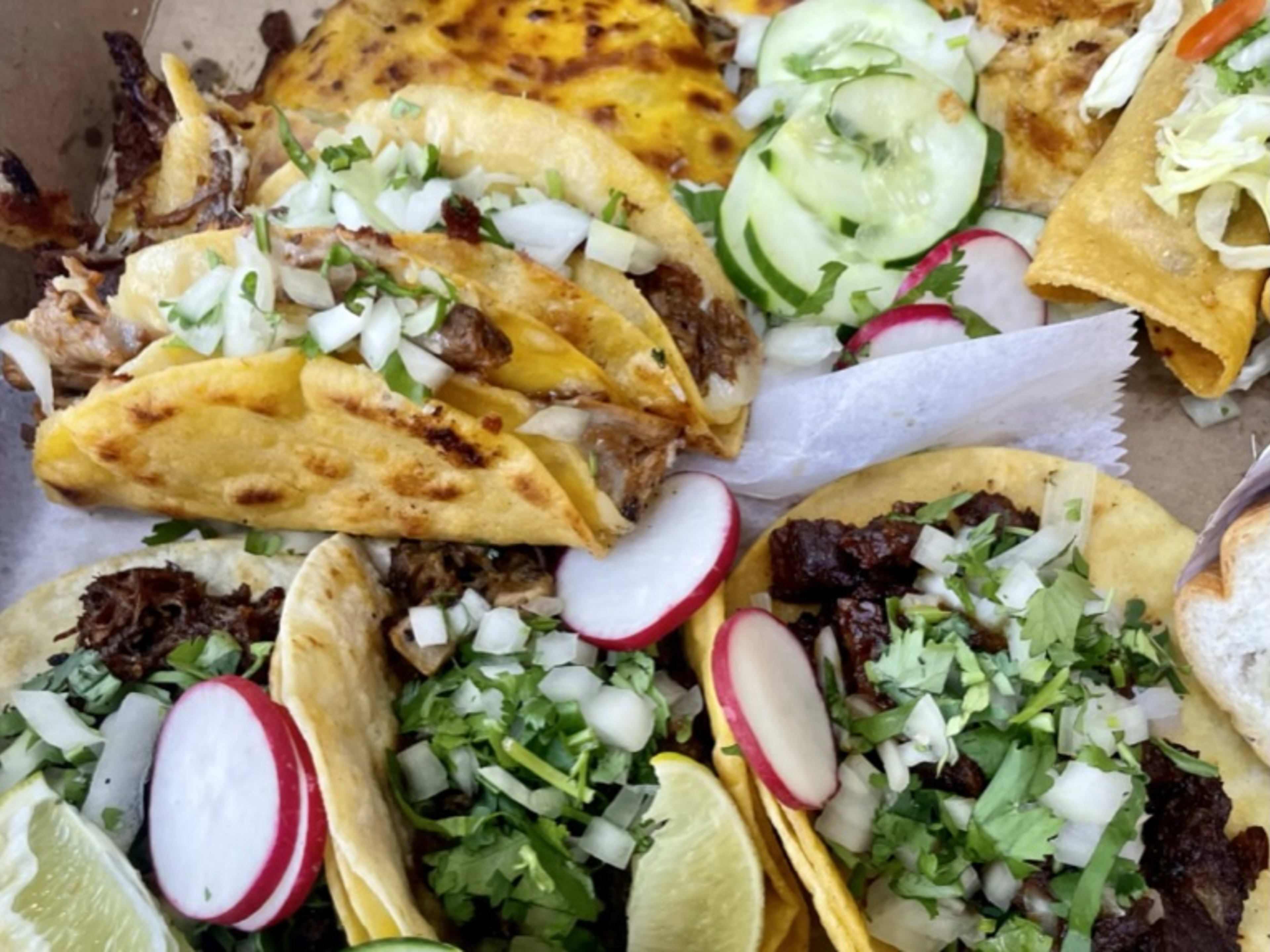 Box filled with birria tacos and a quesadilla.