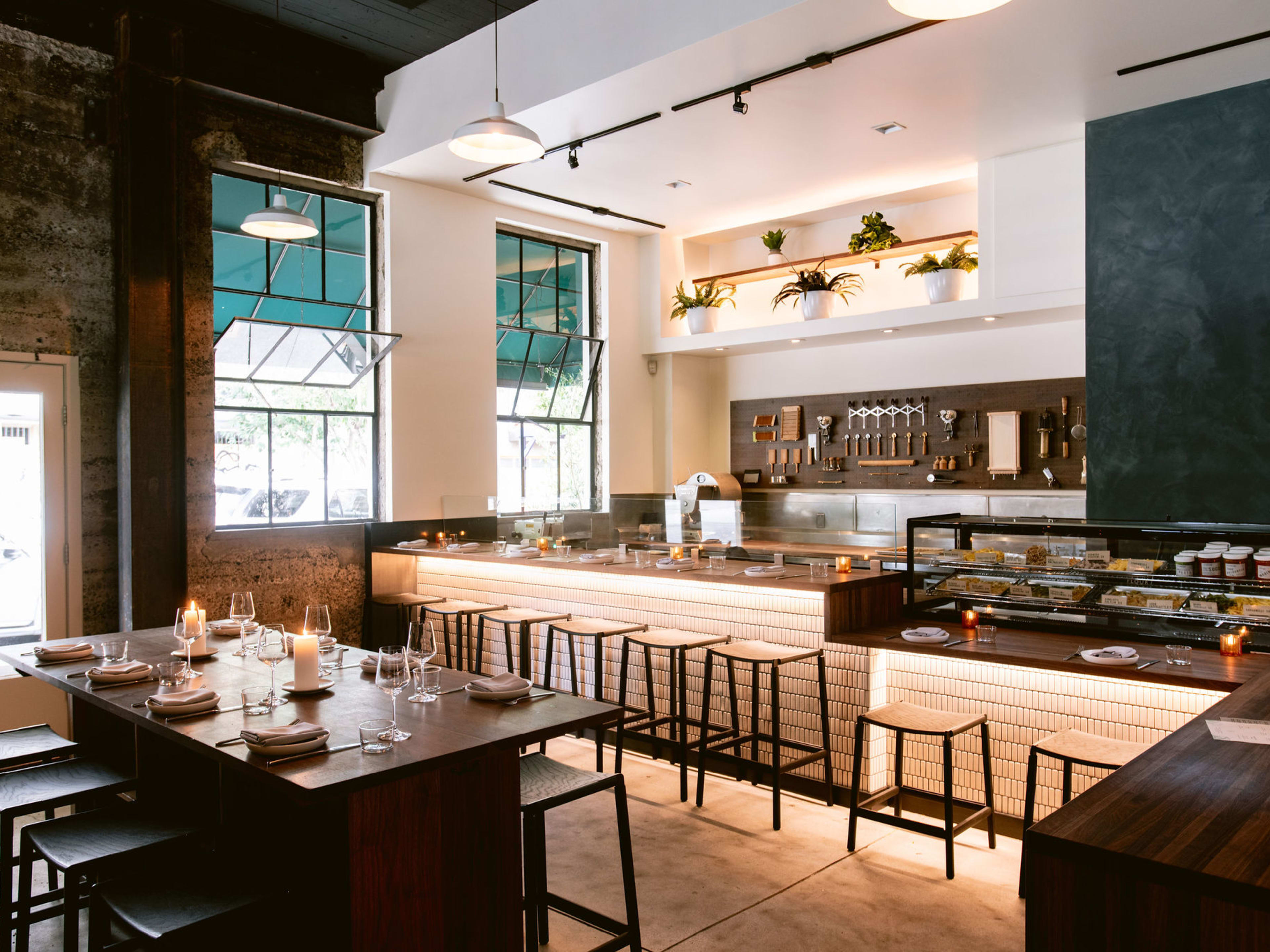 The bar seats and communal table inside Flour + Water Pasta Shop