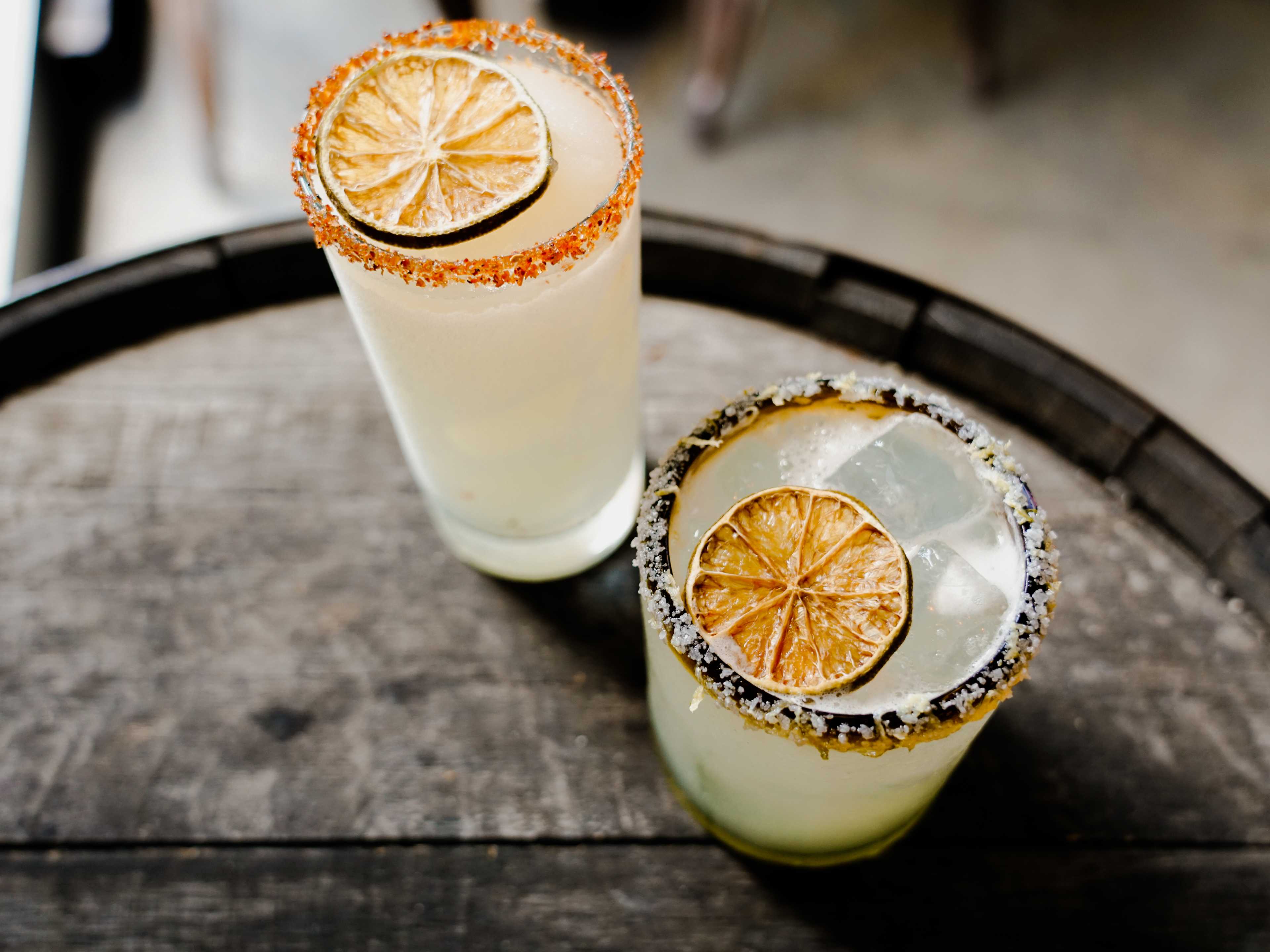 two margaritas on the rocks at Eight Row Flint with salted rims and citrus wheels on top