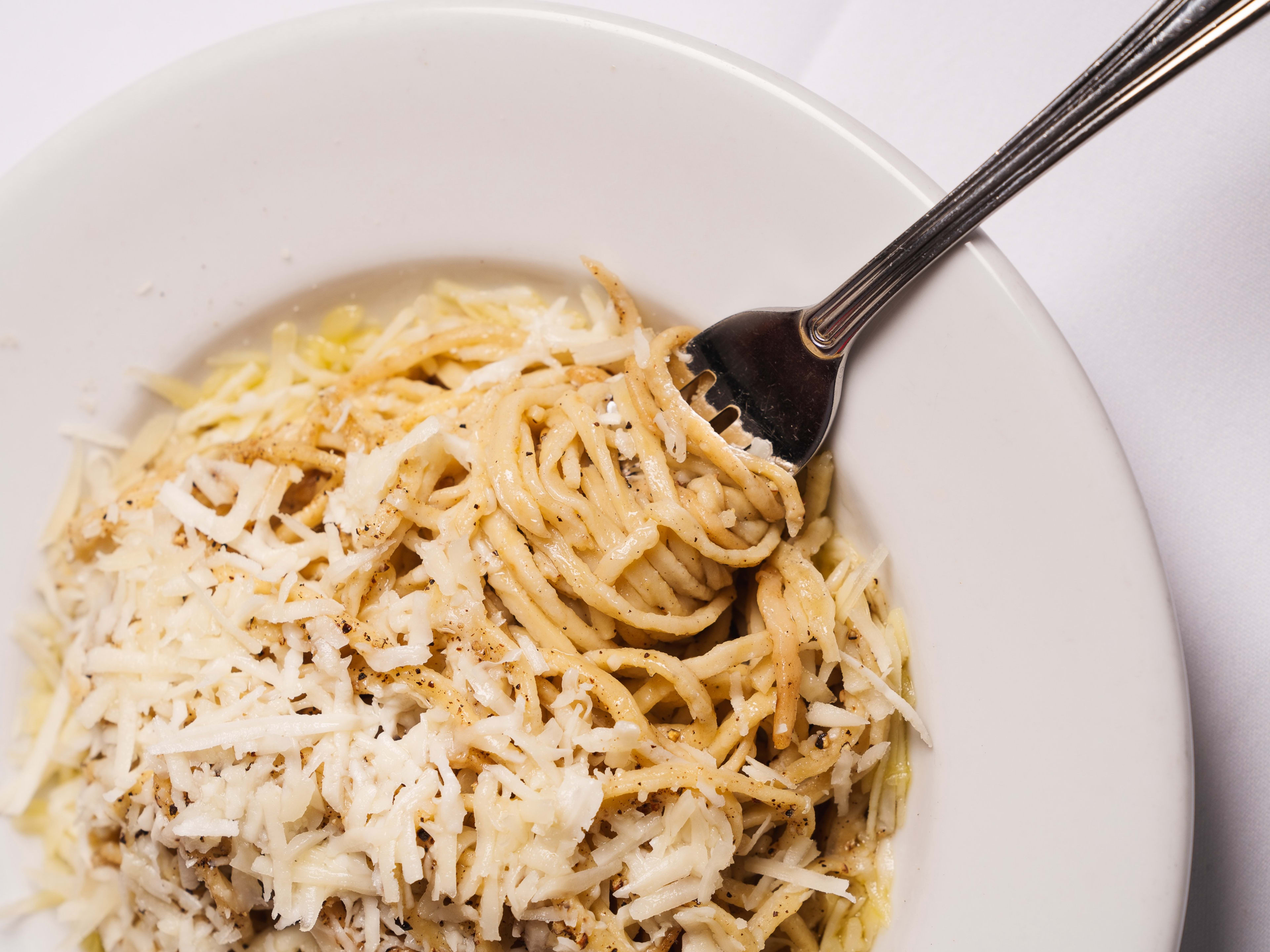 Bowl of cacio e pepe with a fork in it