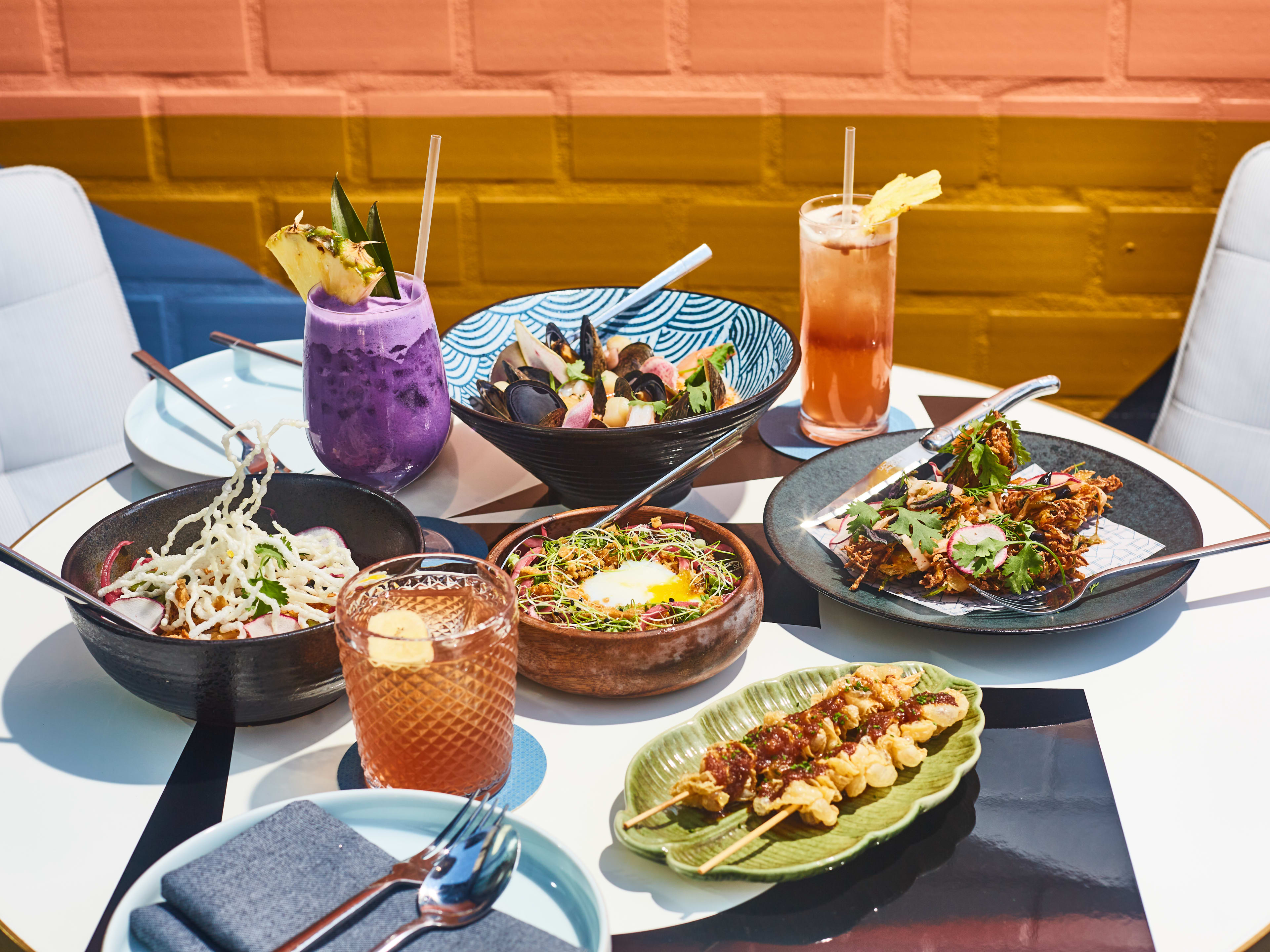 A spread of chowder, sisig, cocktails, and more at Abacá