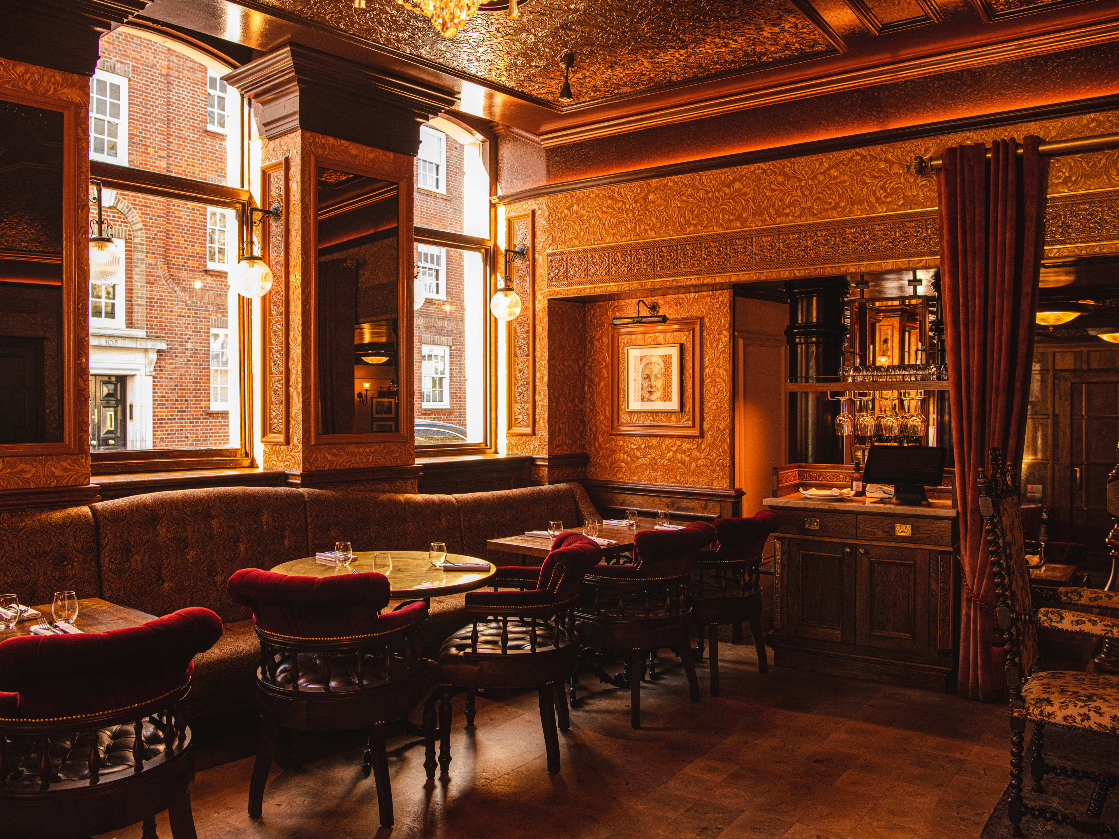 The red and gold accented dining area at The Cadogan Arms.