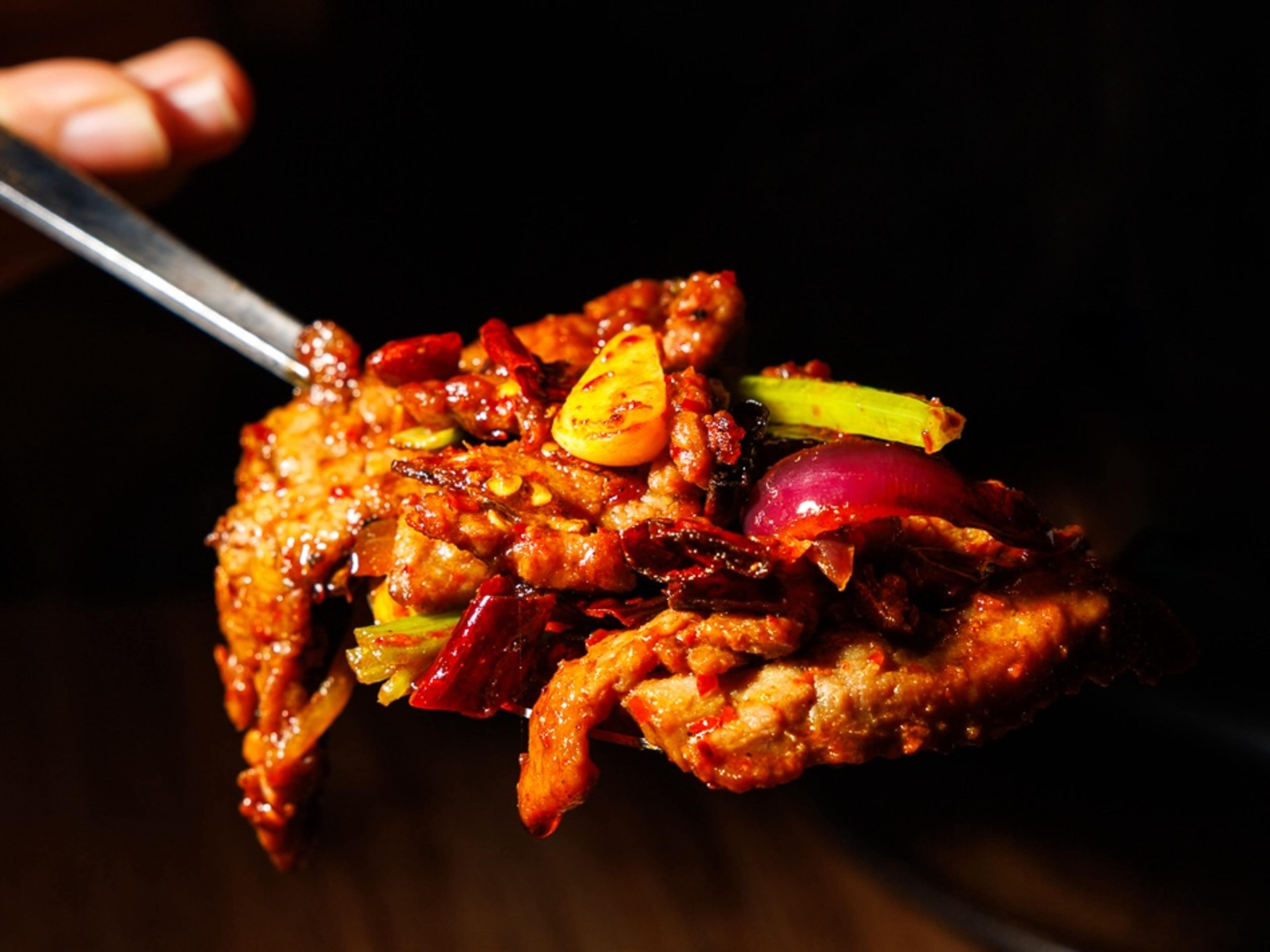 Cumin beef on a spoon.