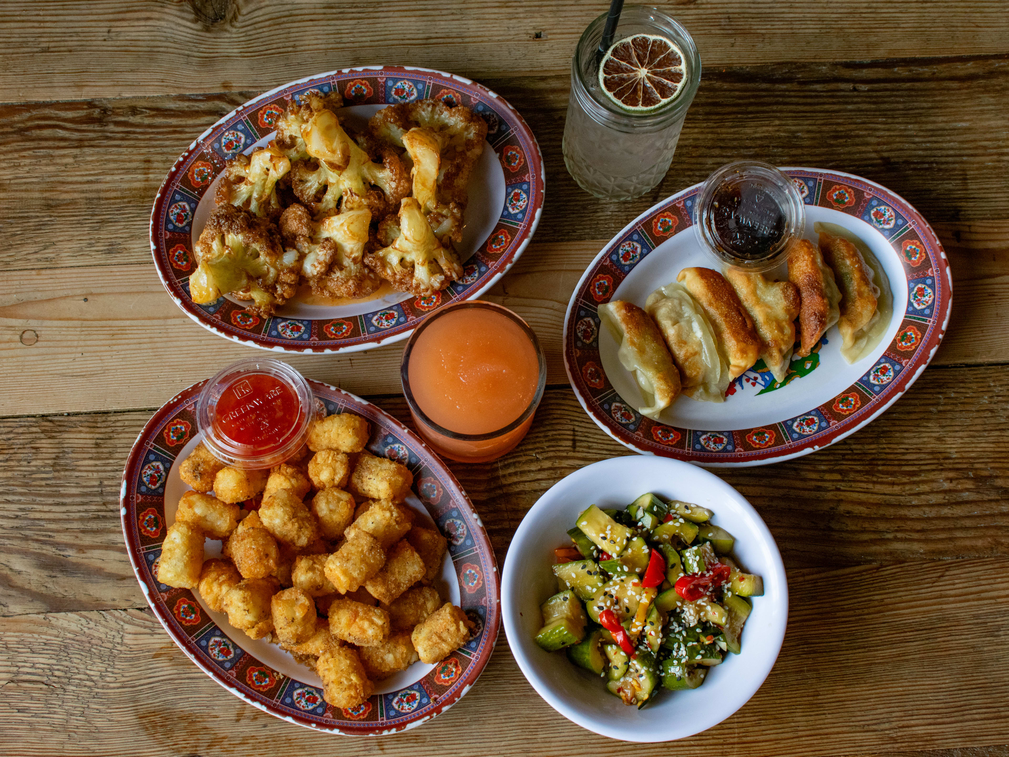 Dumplings, tater tots, cucumber salad, and cauliflower wings.