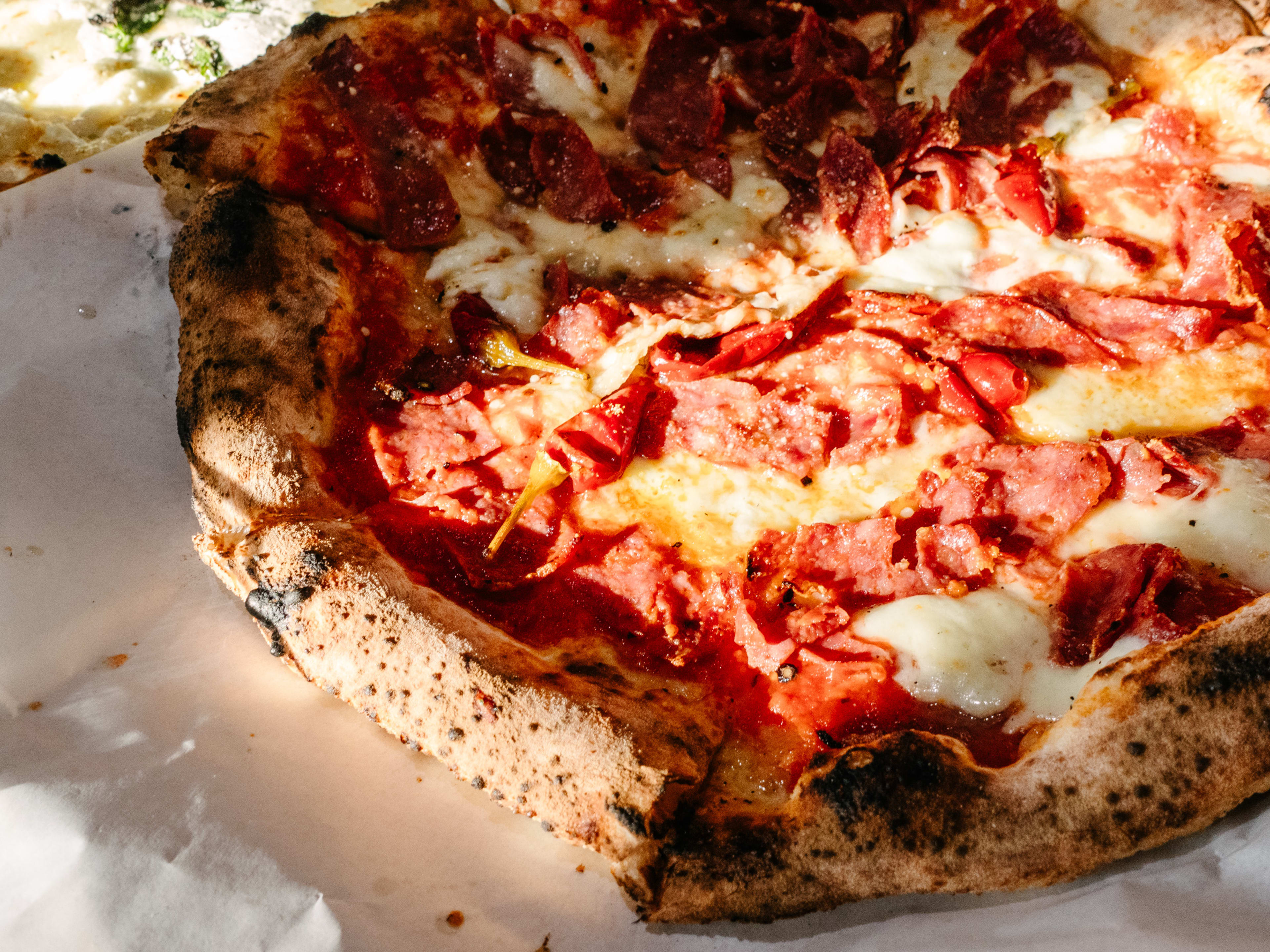 Cheese pizza topped with meat.