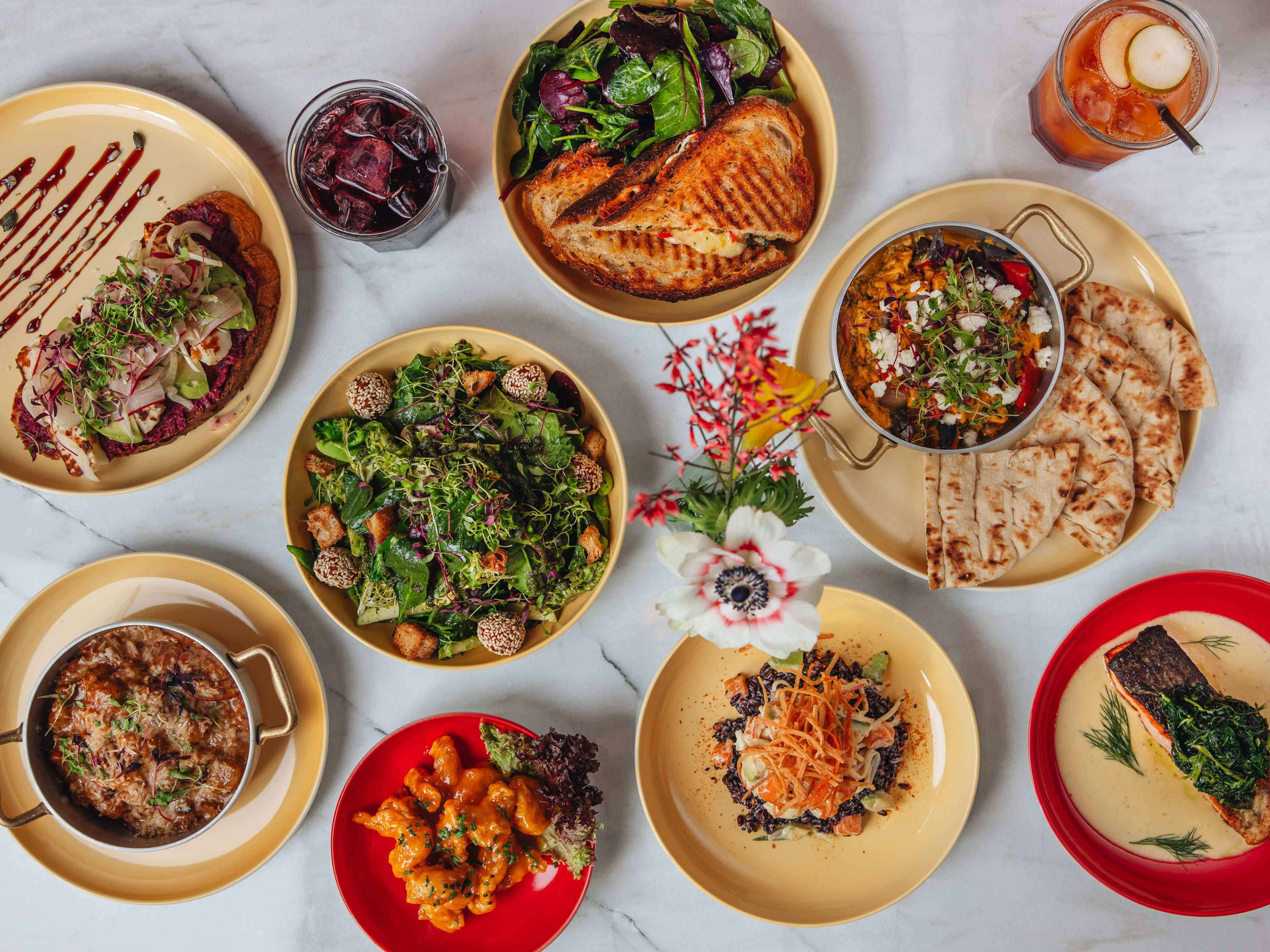 A spread of dishes from Apple Butter Cafe on a white marble table.