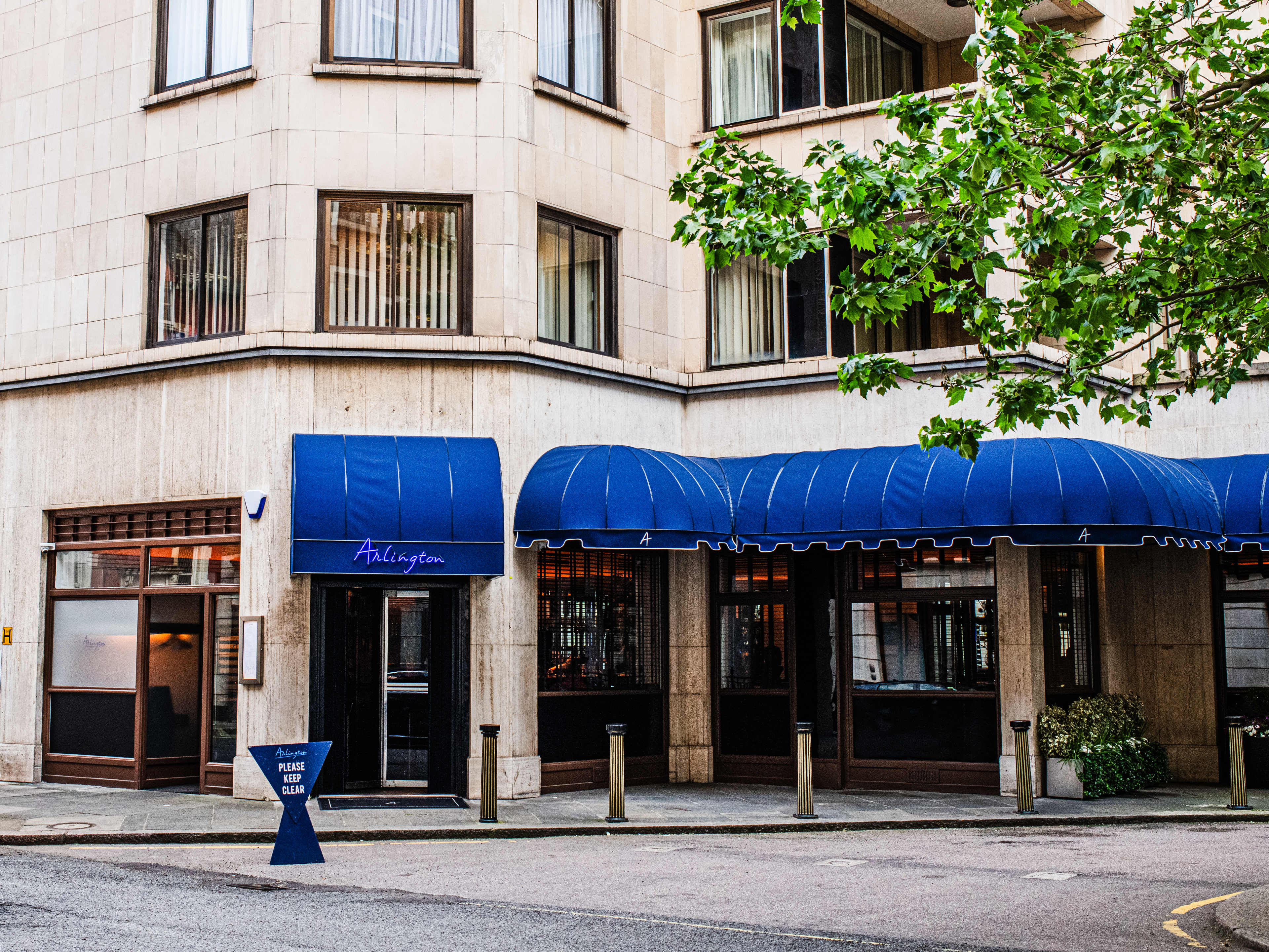 The exterior of Arlington with blue awnings.