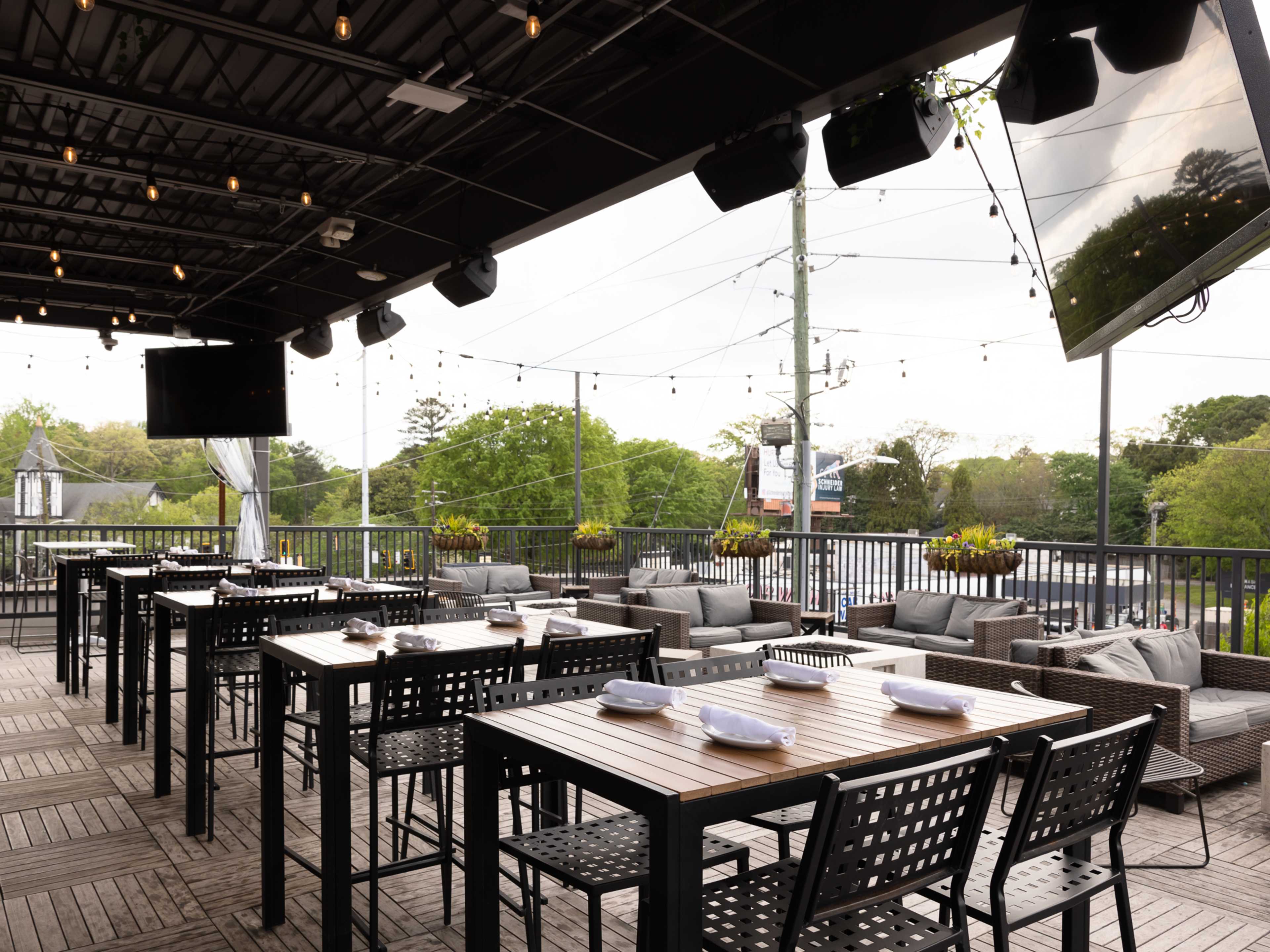 Grana's rooftop with TVs and patio couches.