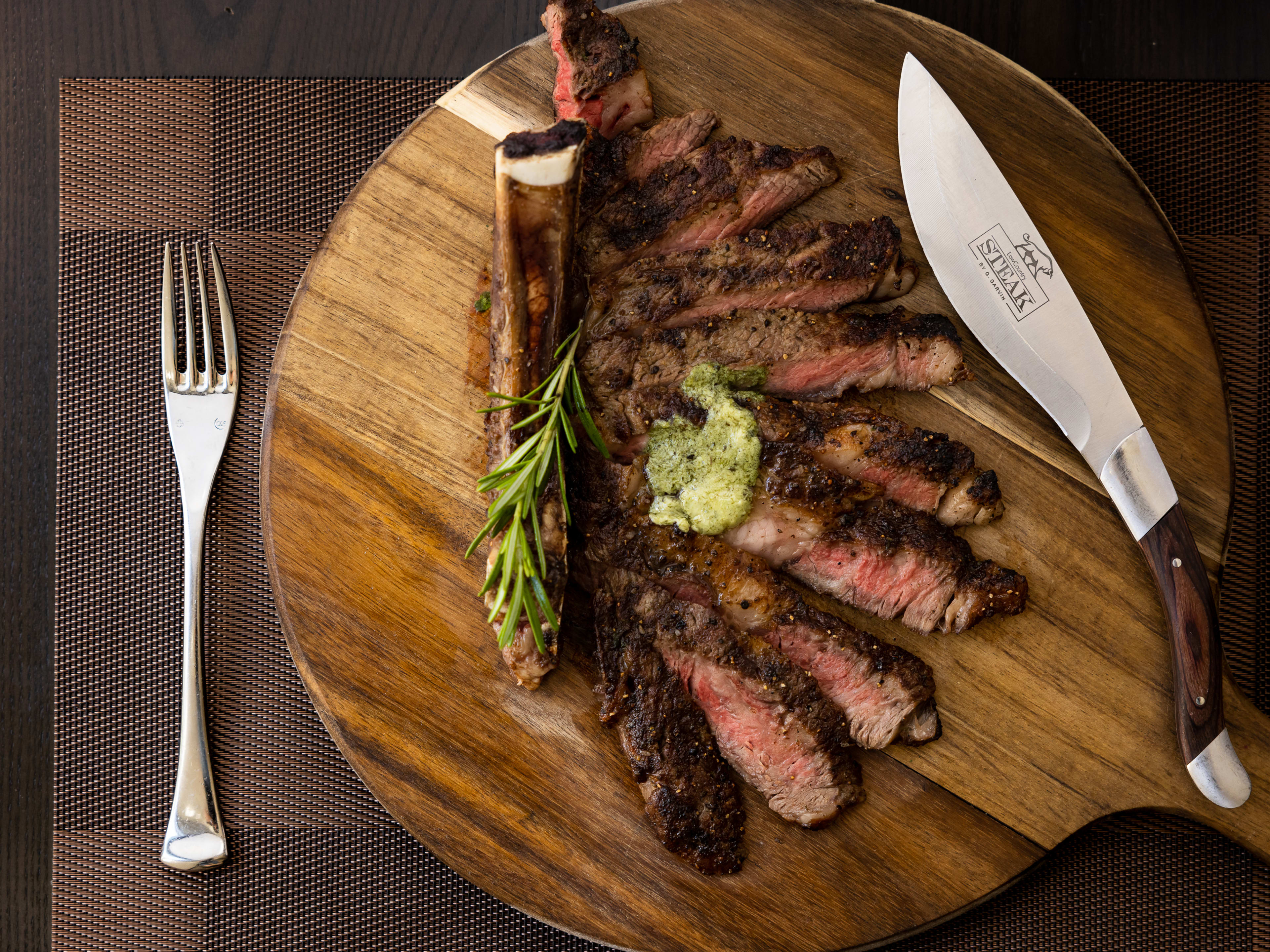 sliced steak with herb butter