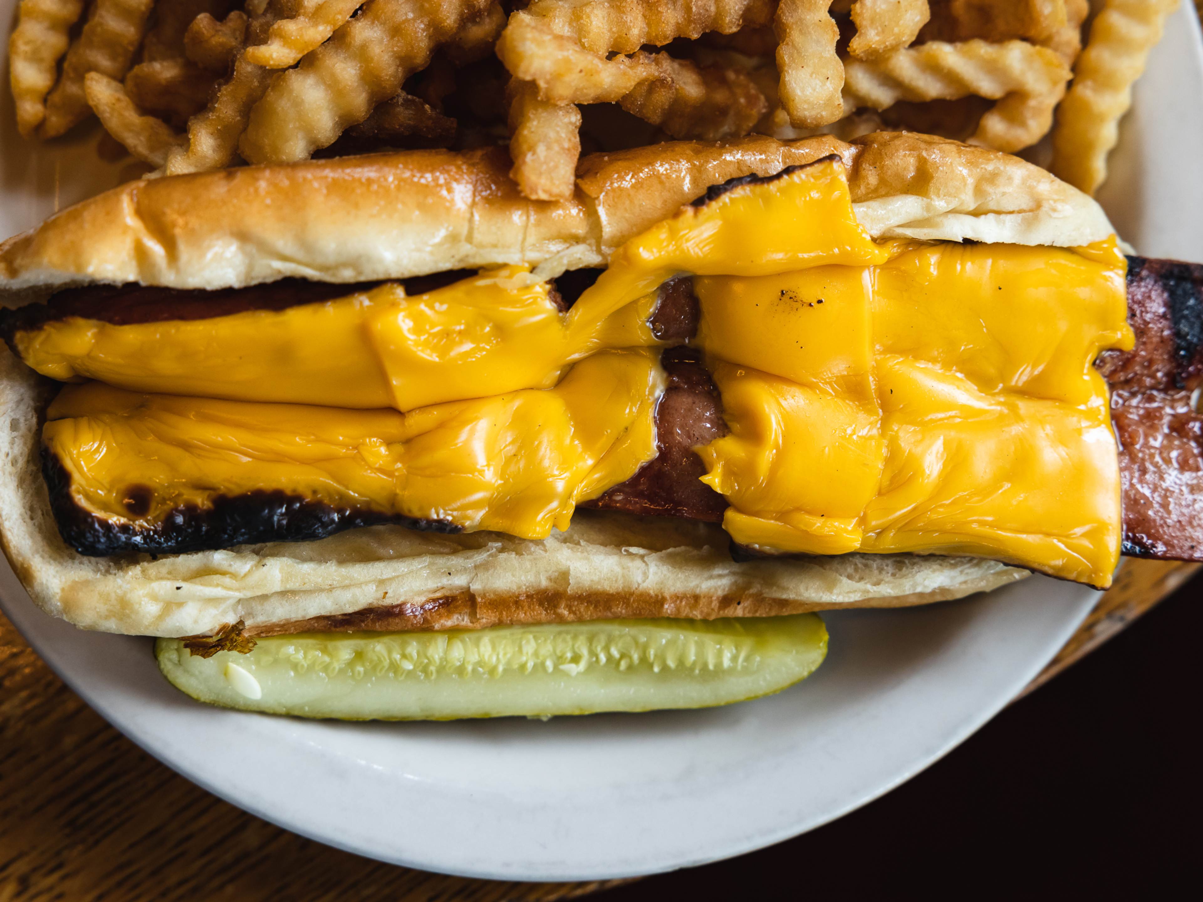 A massive Godzilla Dog with melted cheese.