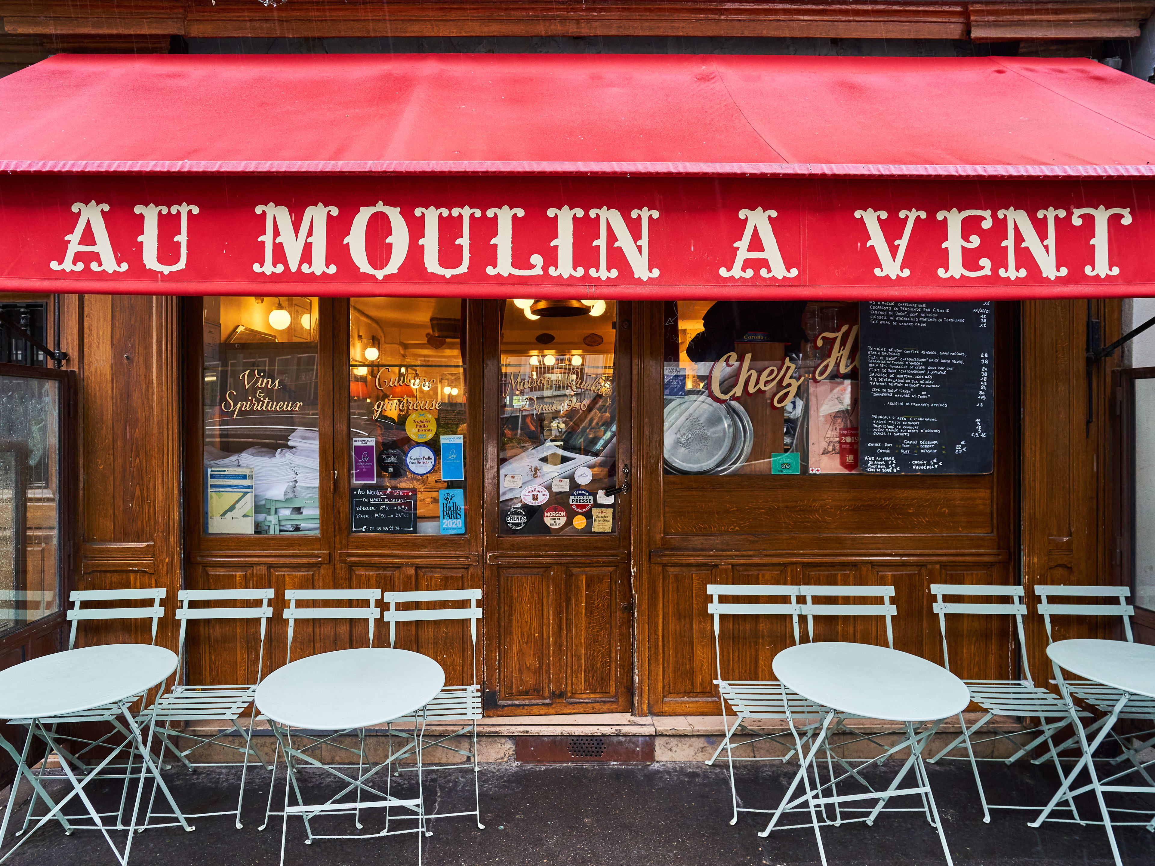 Wooden exterior with red awning at Au Moulin a Vent