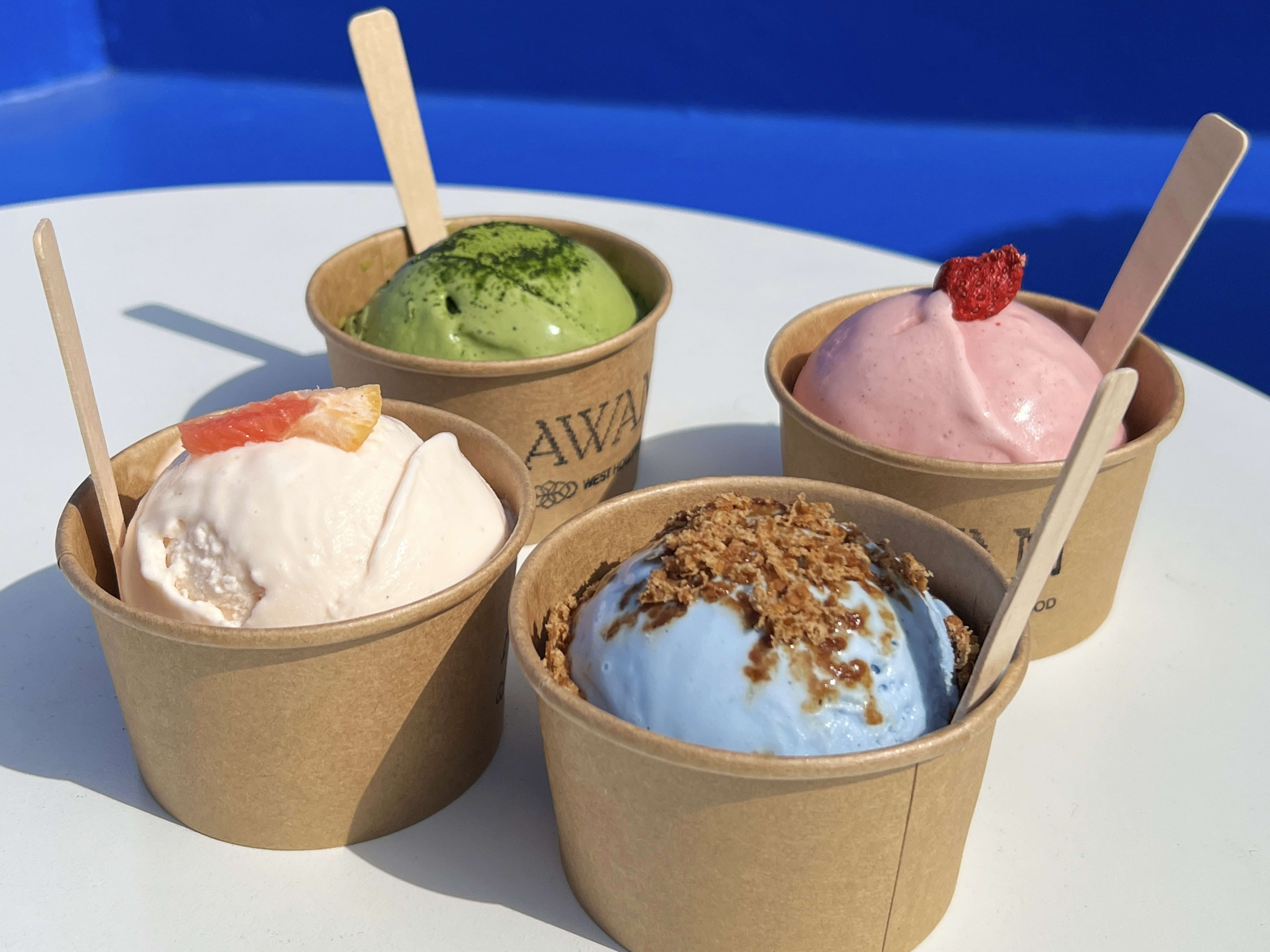 Four different varieties of ice cream scoops in cups from Awan.