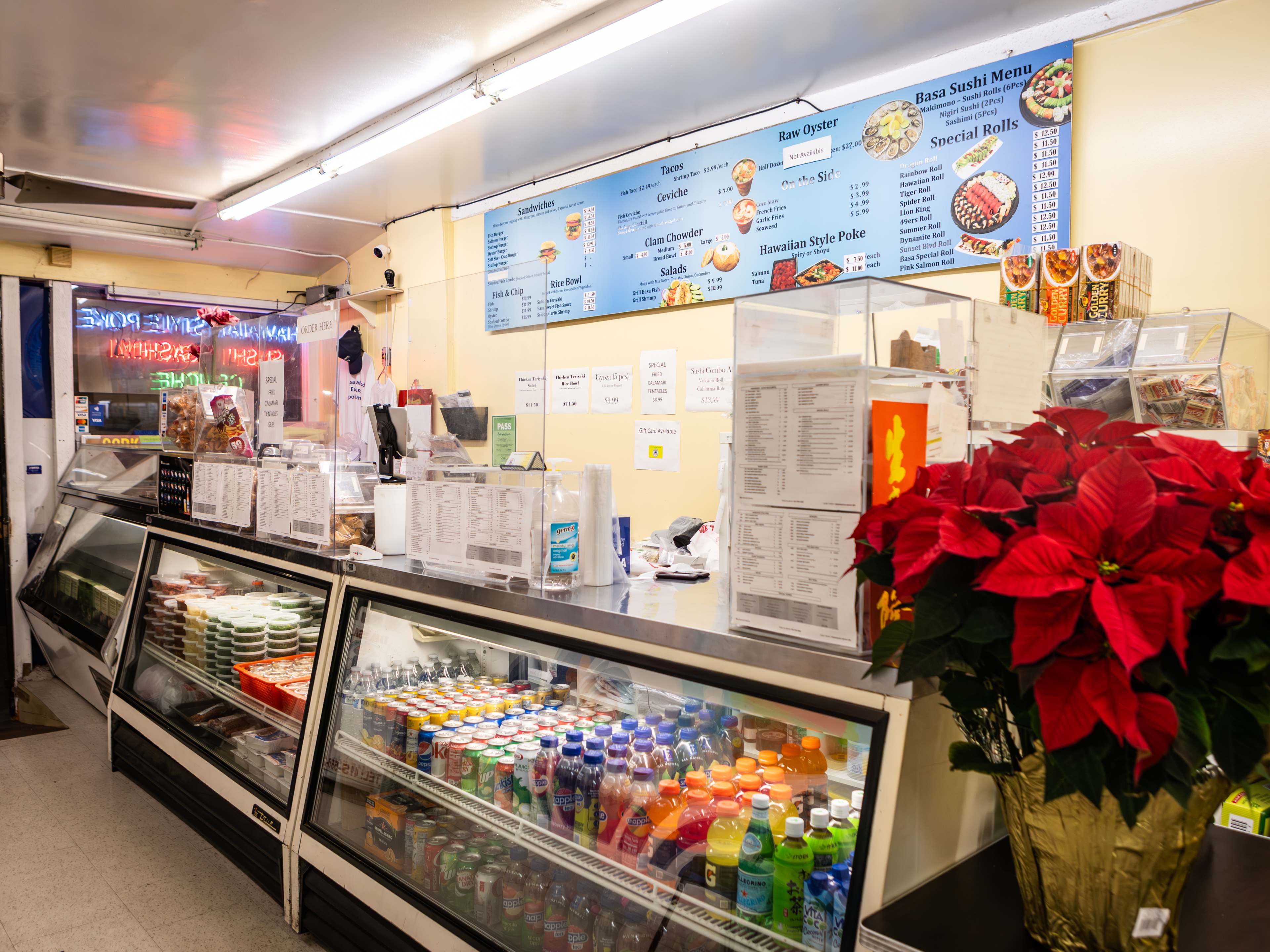 The interior sushi case and ordering counter at Basa Seafood Express