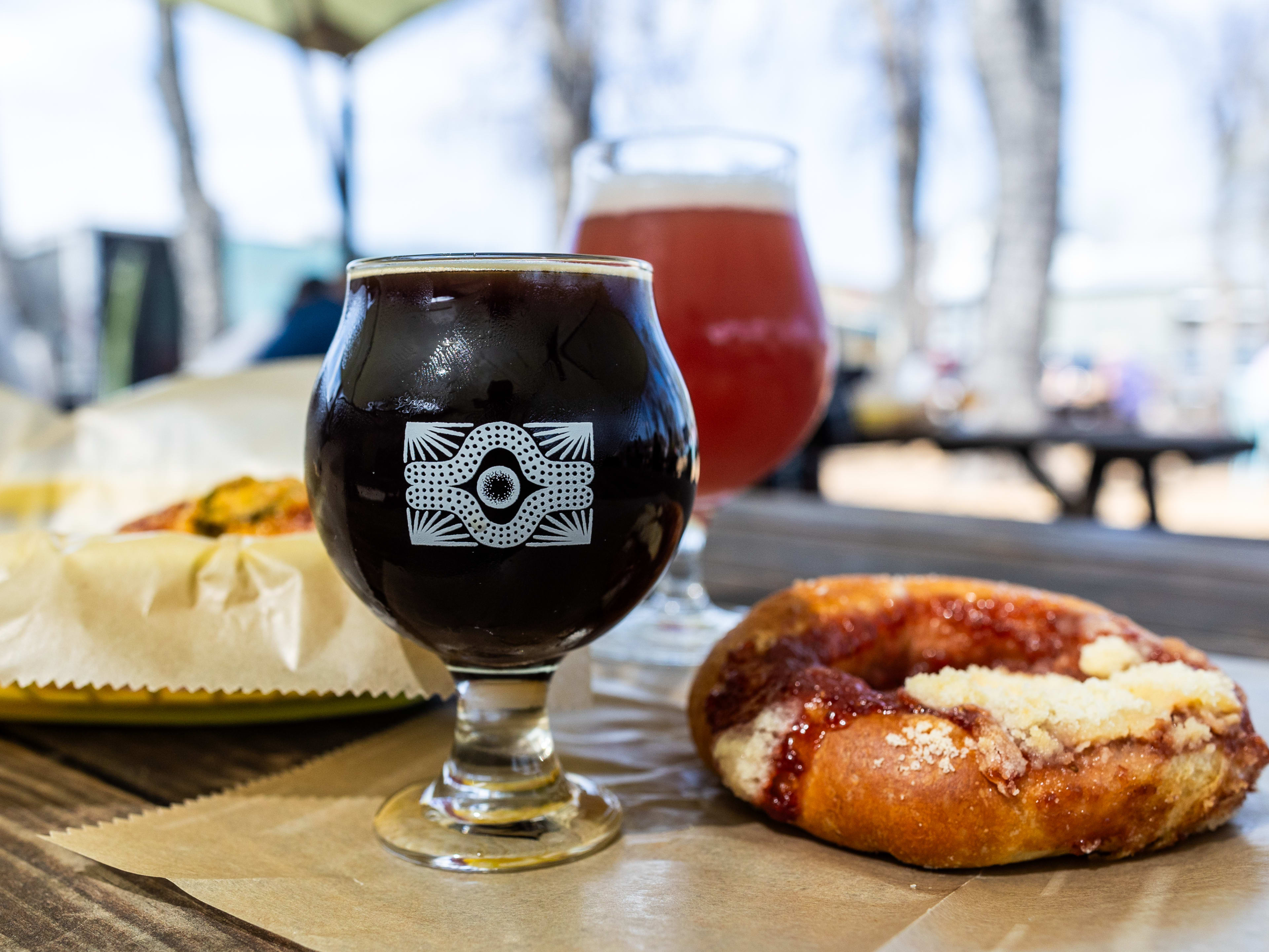 The Batch of Jungle Bird beer at Batch Brewing next to a Kolache.