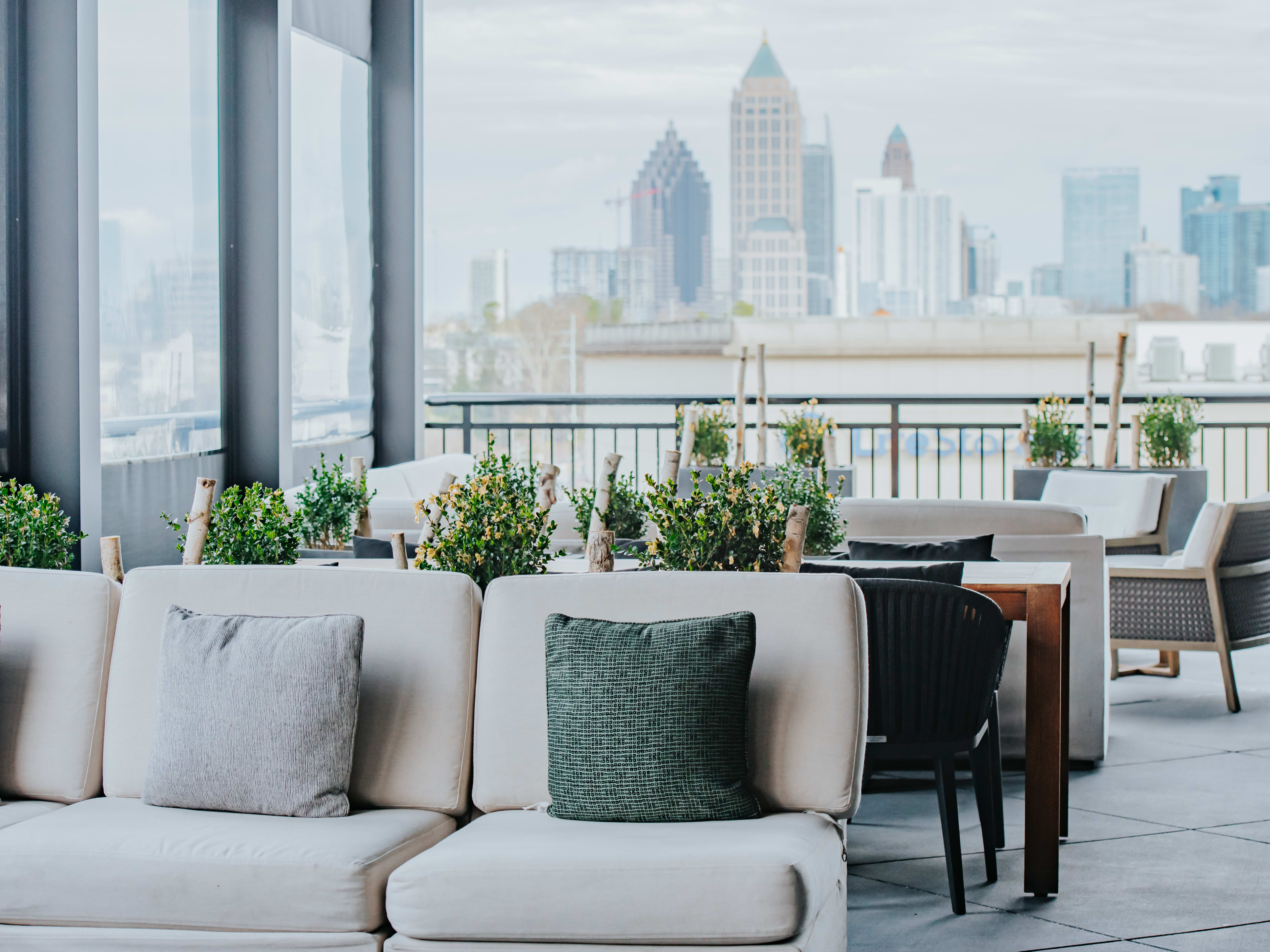 A rooftop patio with the Midtown skyline in the distance.