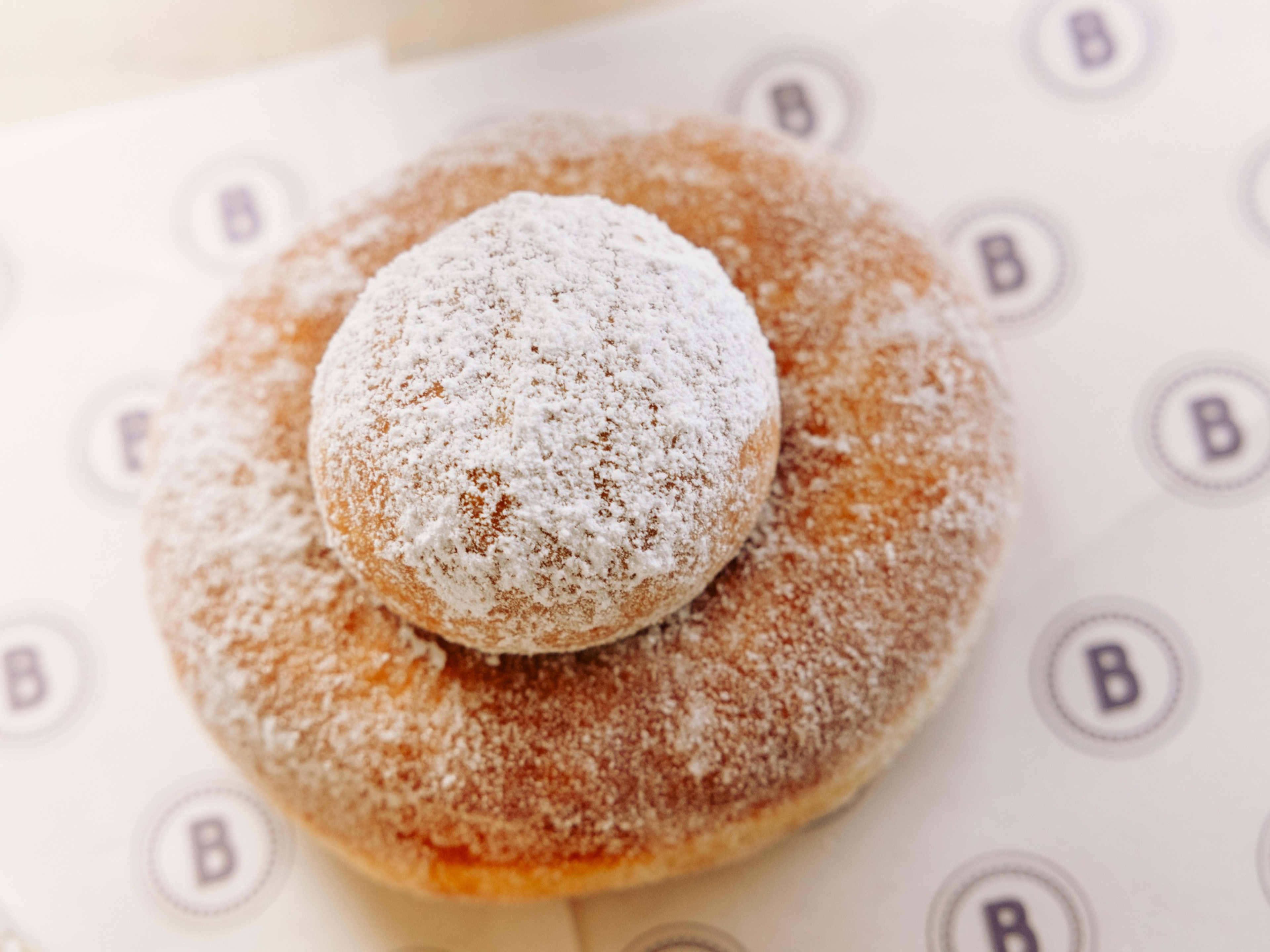 Sugared donut with donut hole in the middle