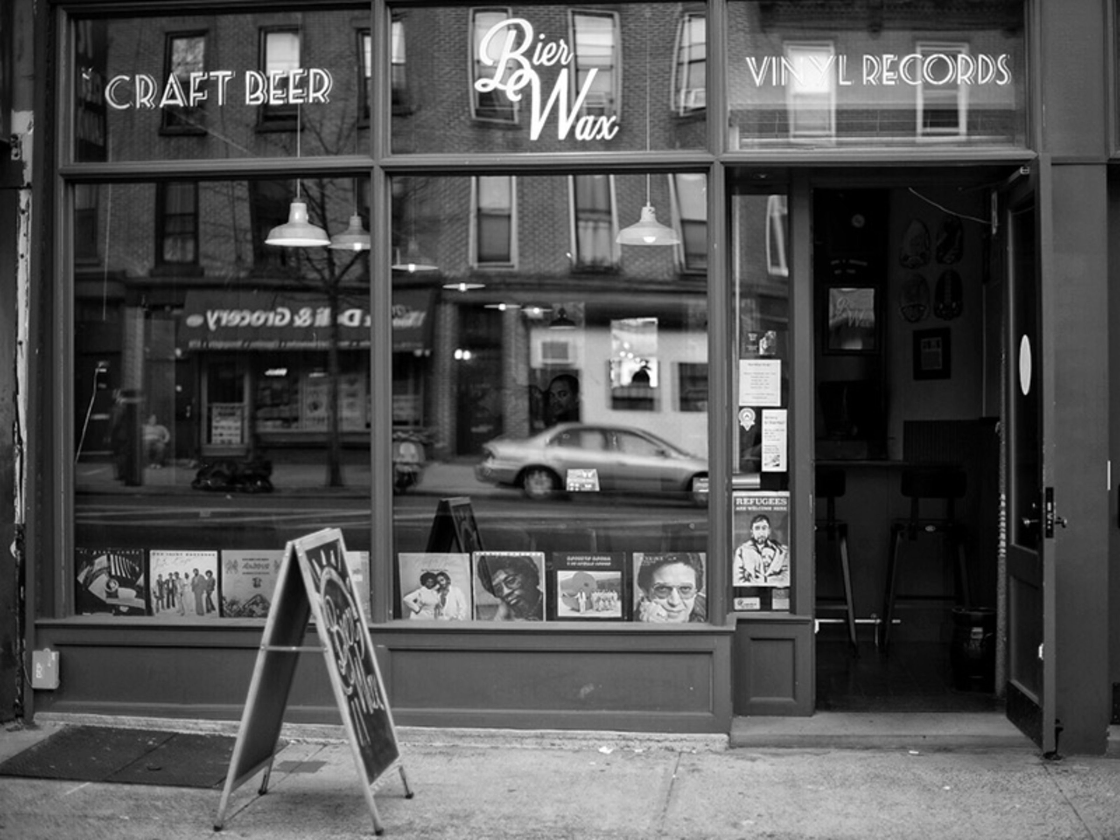 A black-and-white photo of the exterior of a bar.