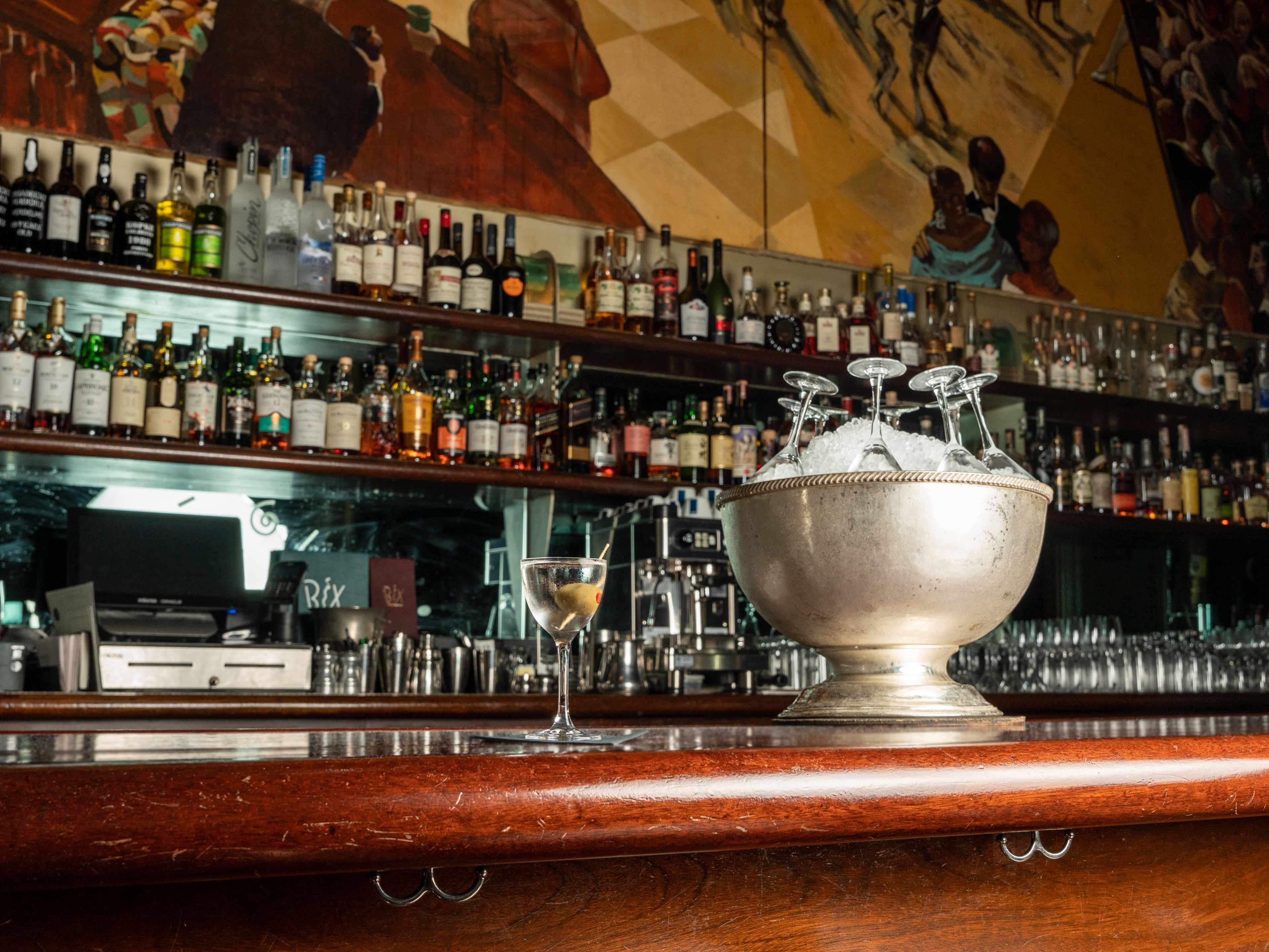 bar with bucket of ice and martini glasses upside down inside of it