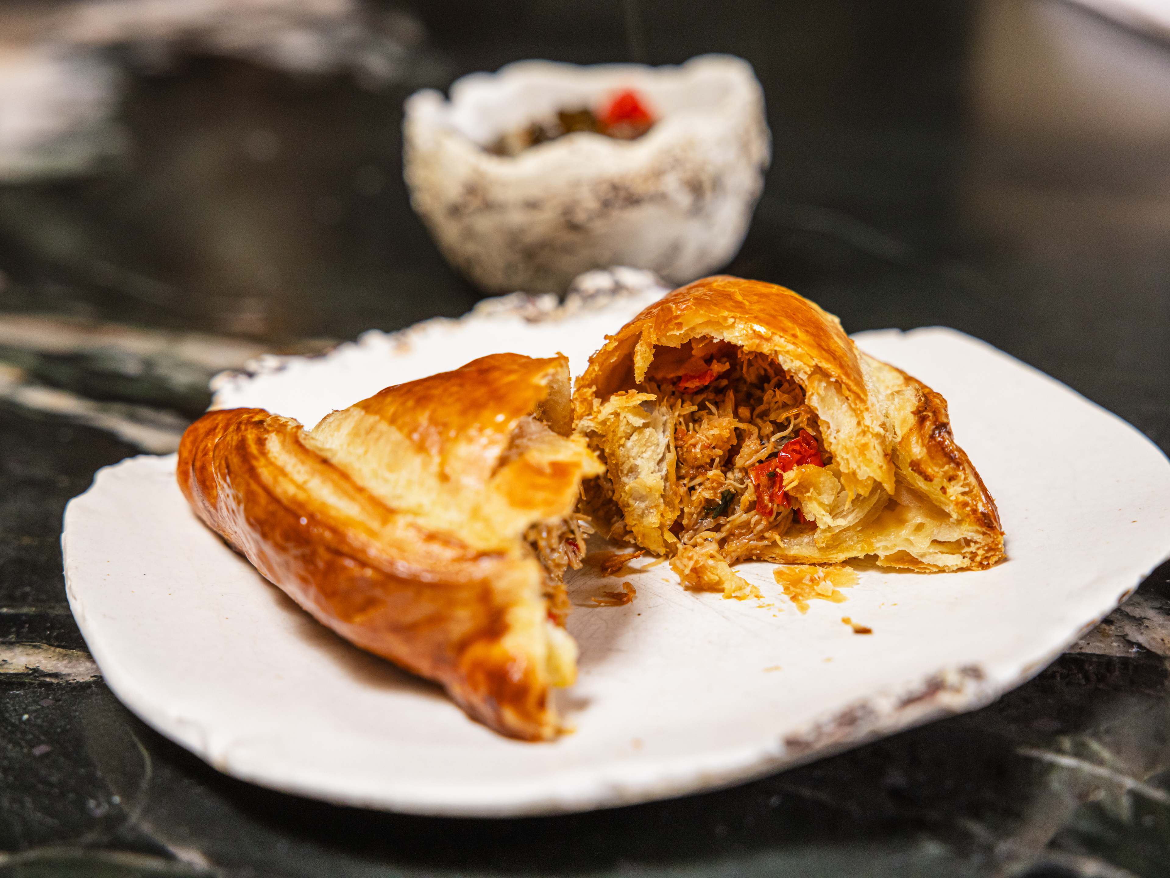 A large empanada split in half to show the crab inside.
