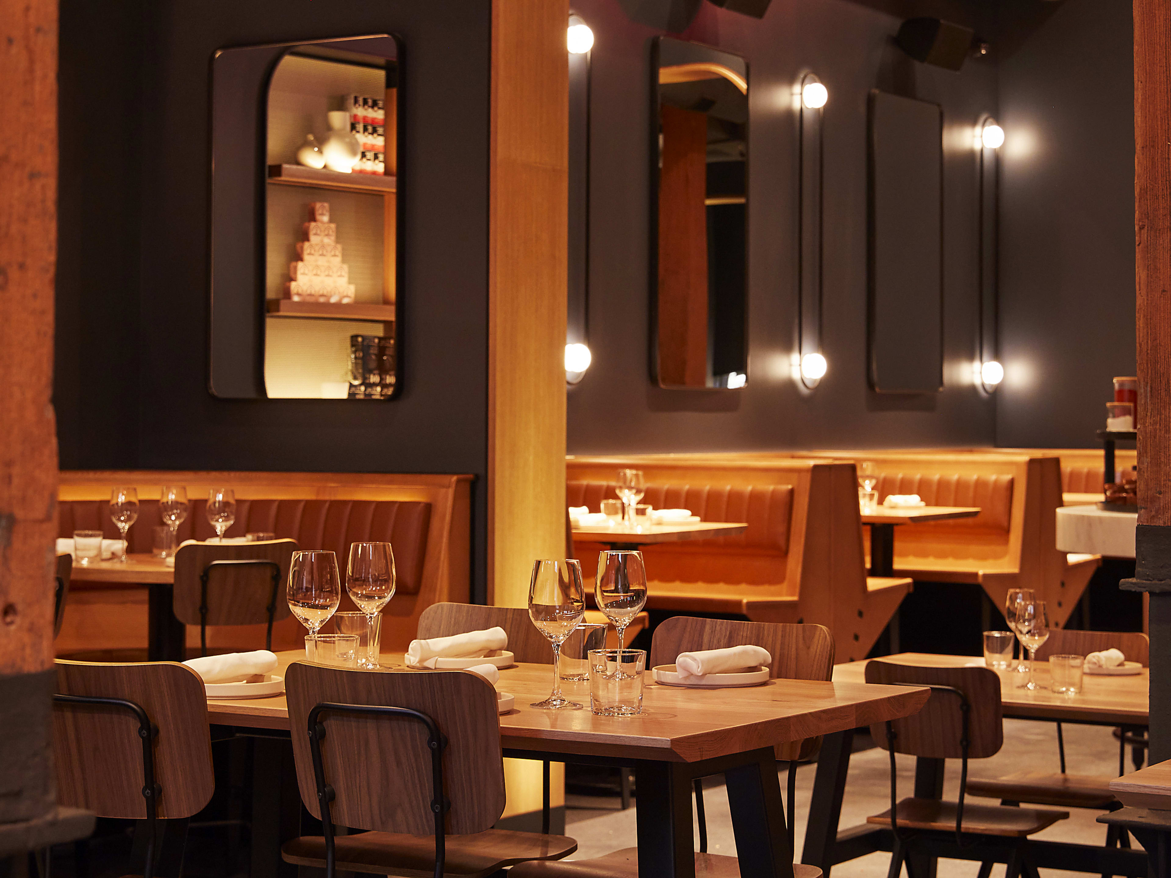 Dimly lit interior dining space lined with light wooden accents at Boqueria