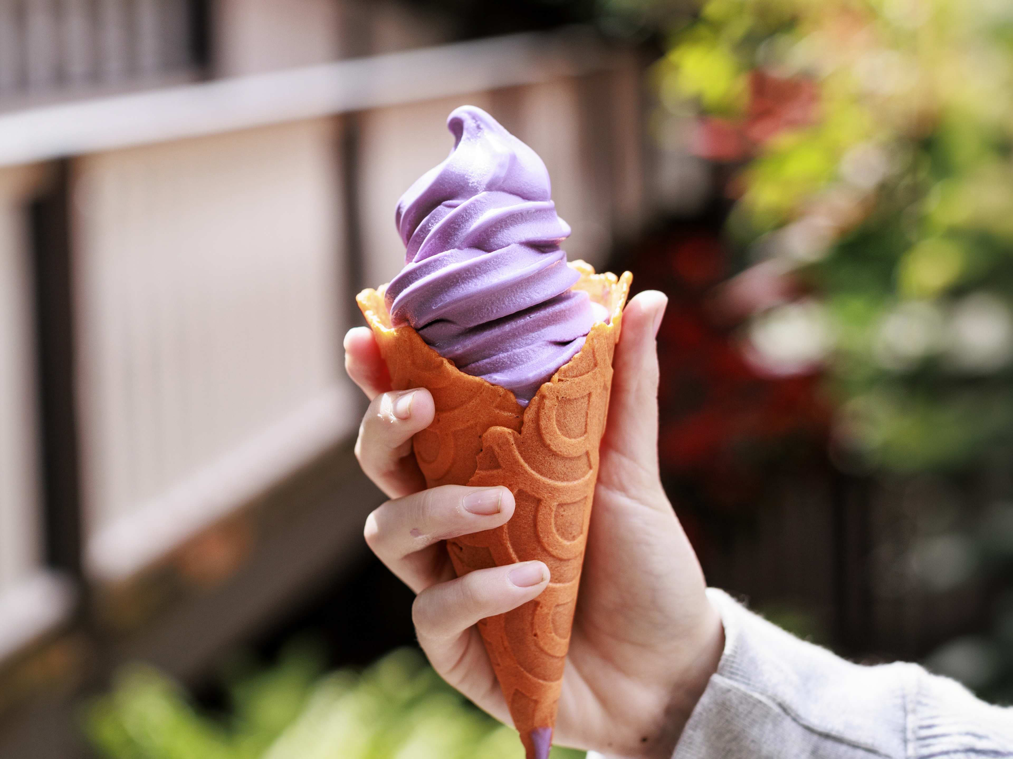 Orange cone stuffed with purple ube soft serve