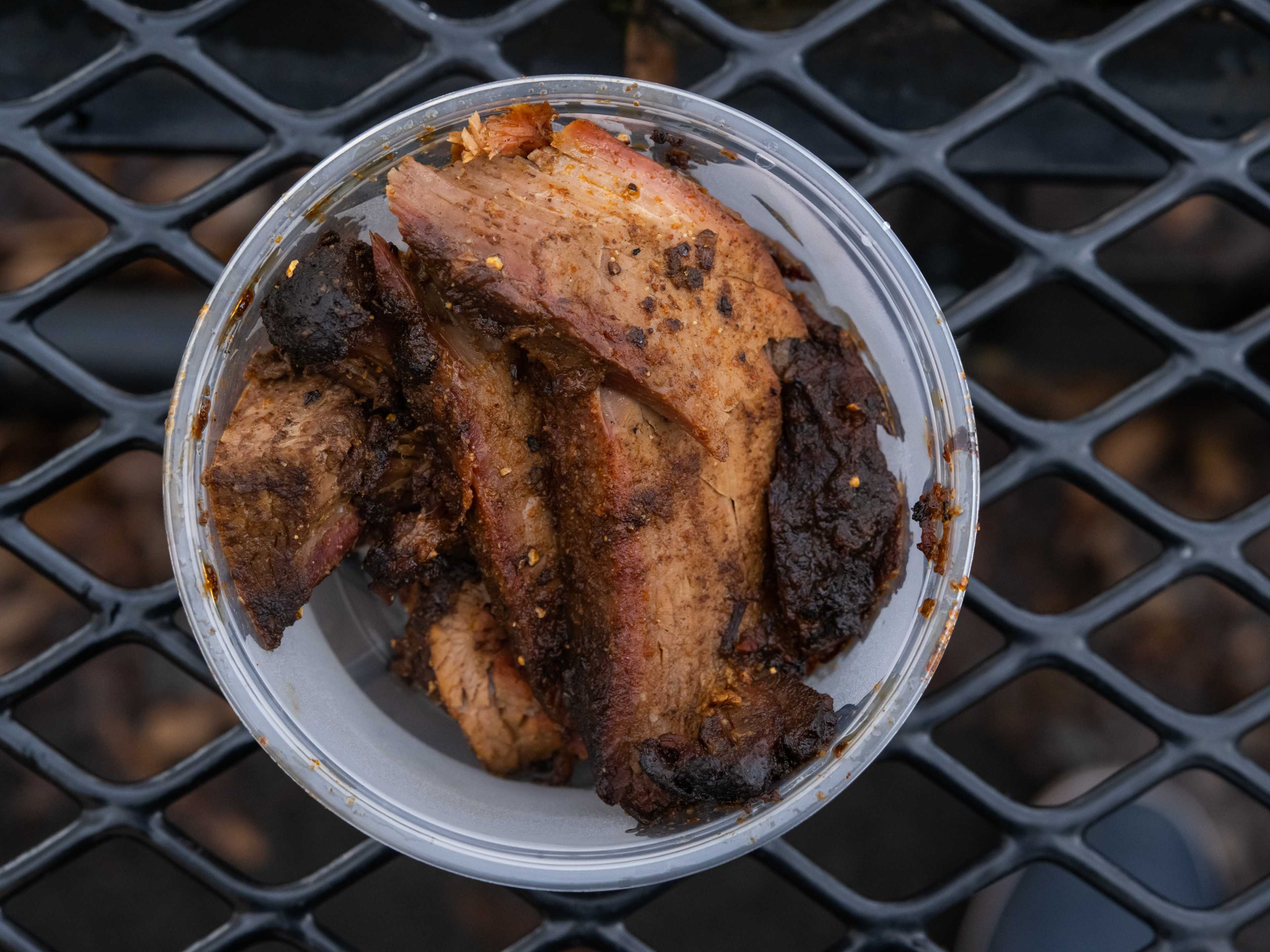 brisket slices in a takeout deli container