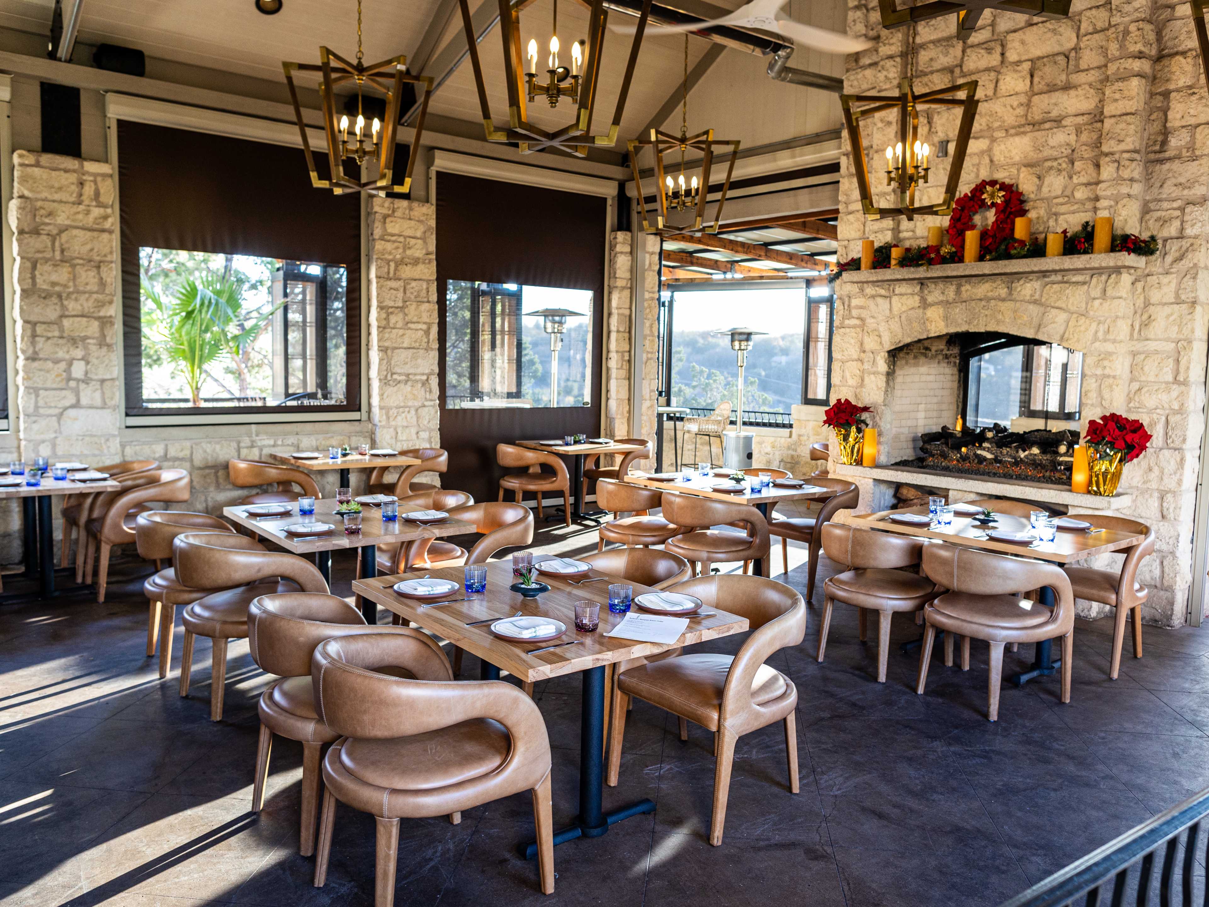 The dining area with a large fireplace and landscape views at Bulevar.