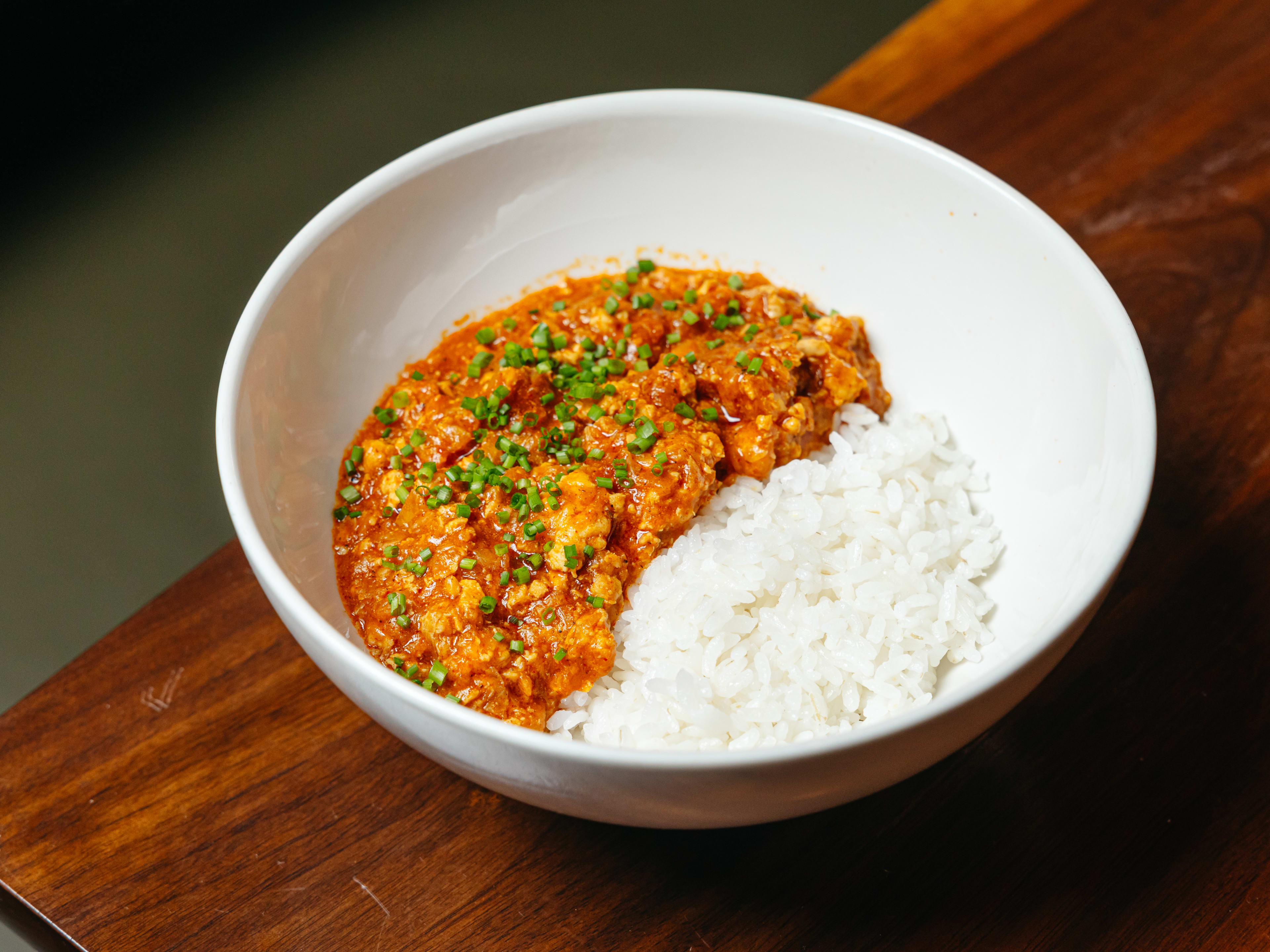 A bowl of chicken curry and rice.