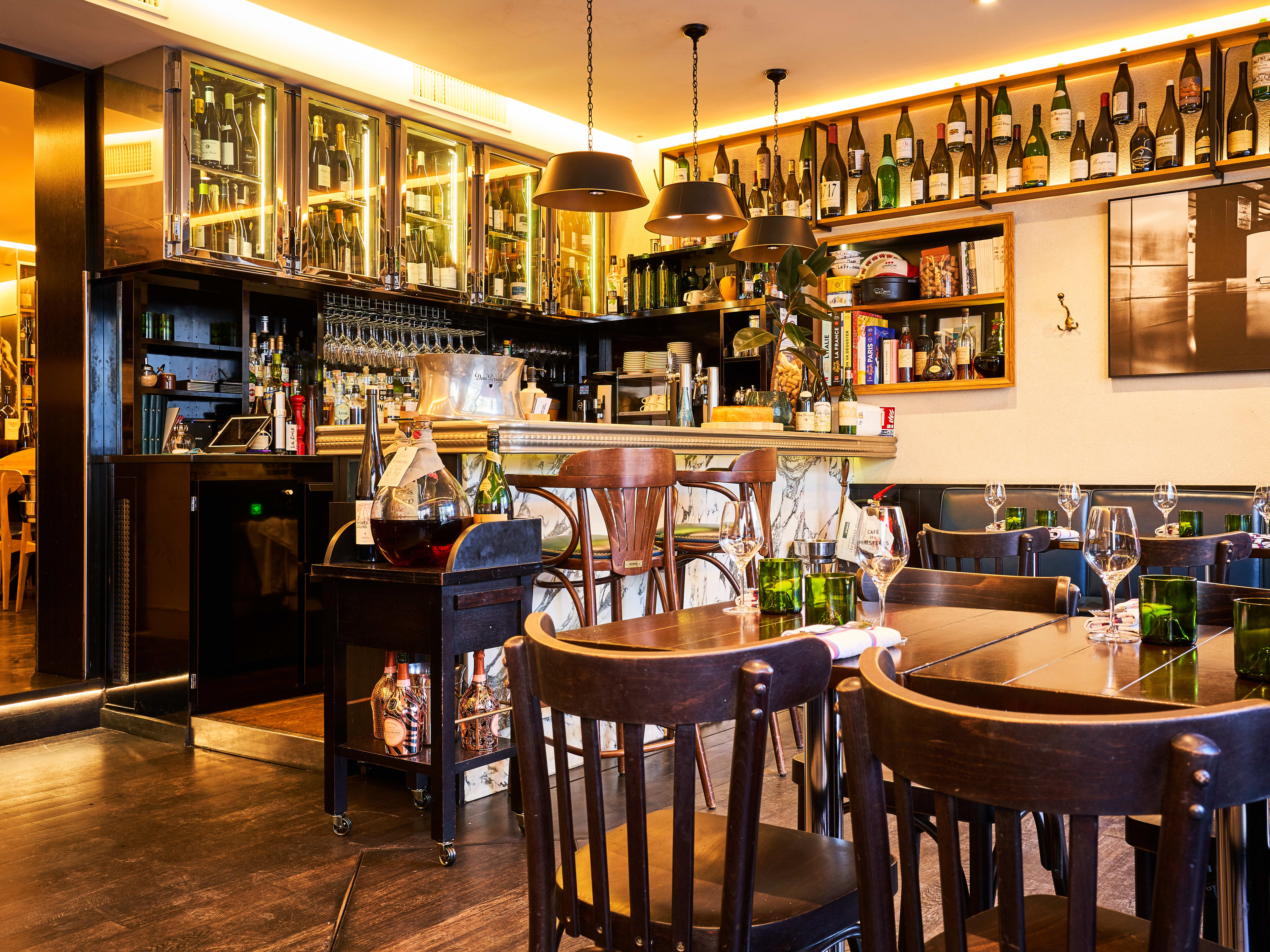 Interior dining space under soft light at Cafe des Ministeres