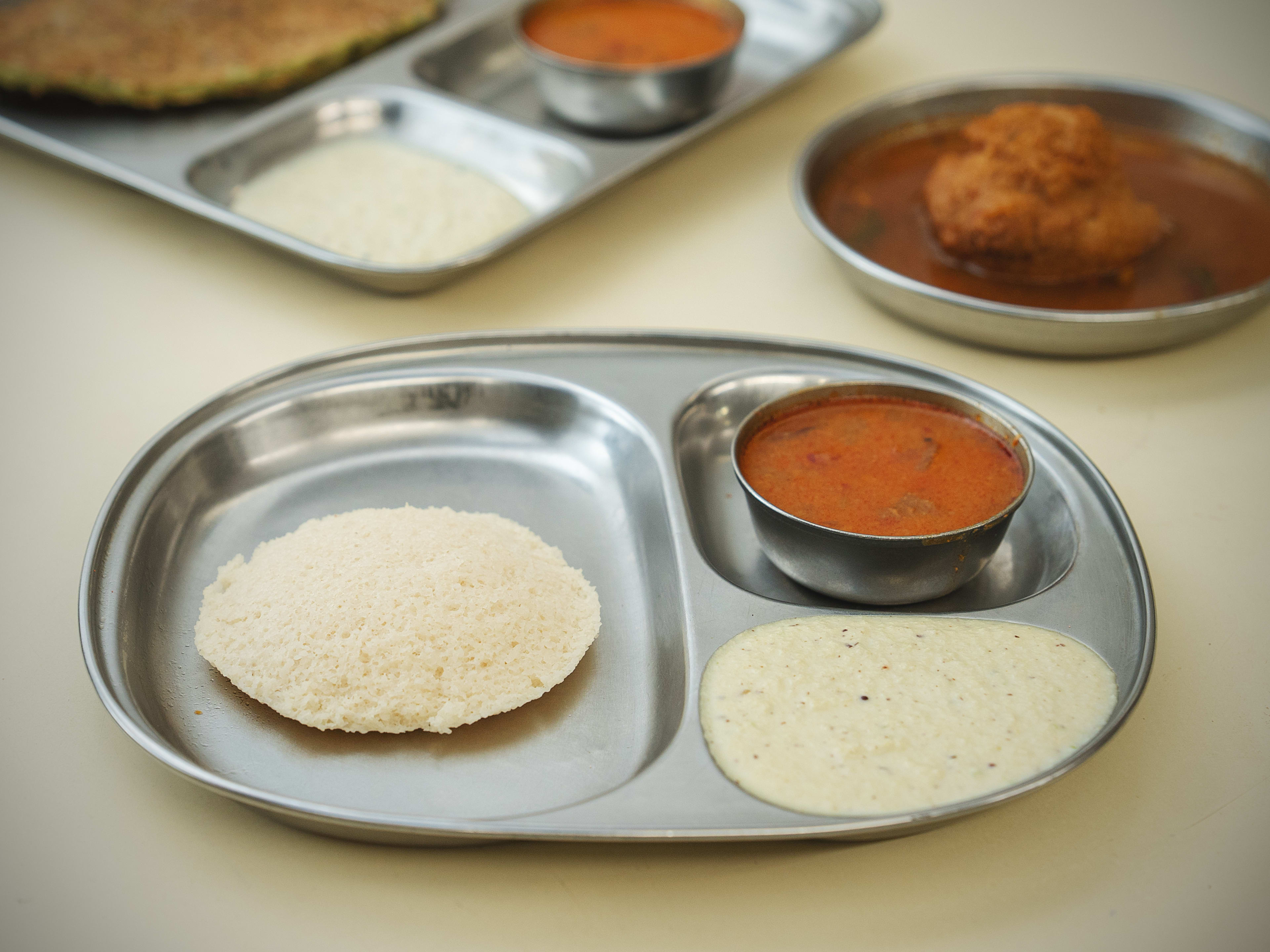 Steamed idli on tin platter at Cafe Madras