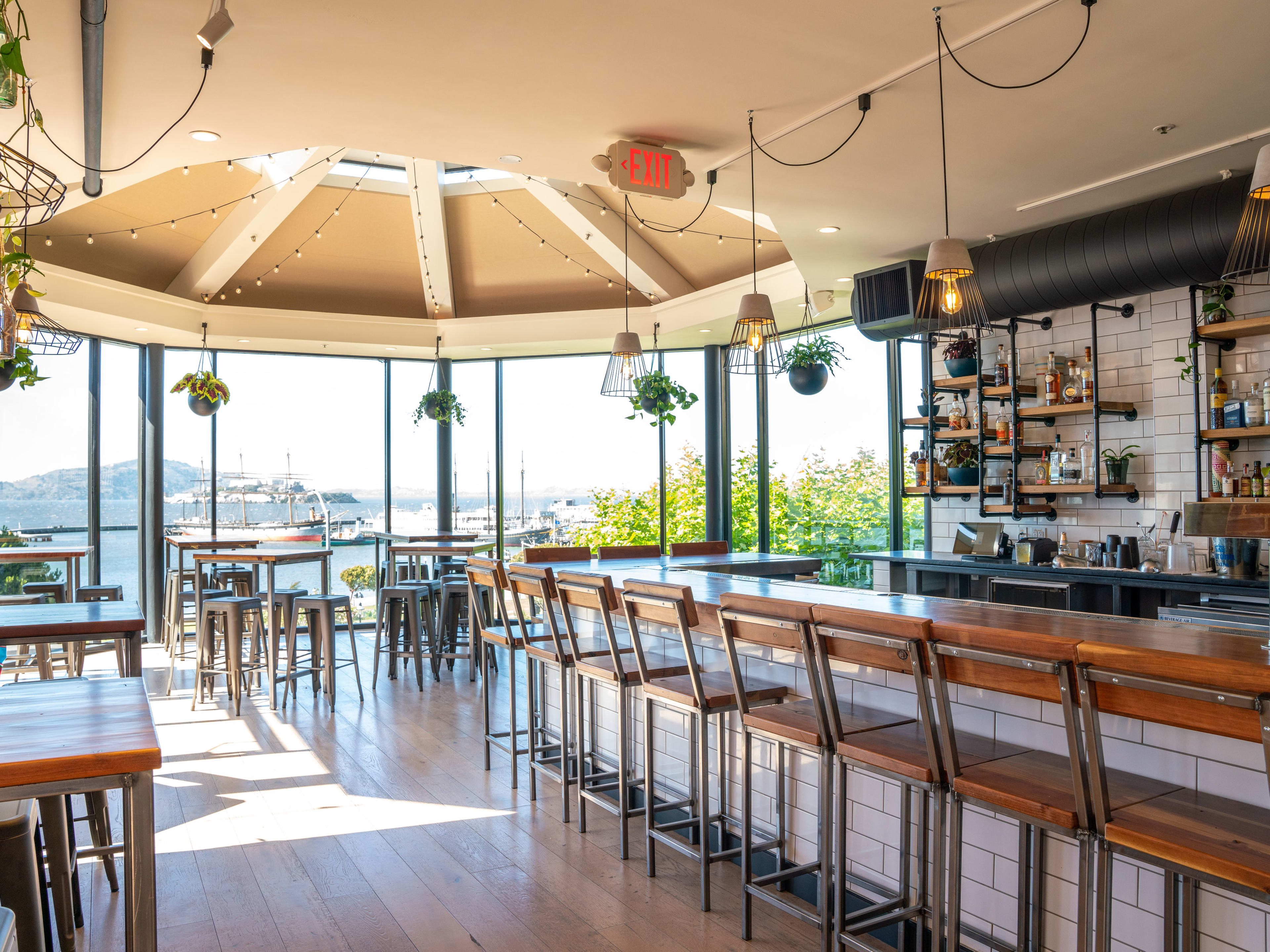 interior of restaurant featuring bar and floor to ceiling windows