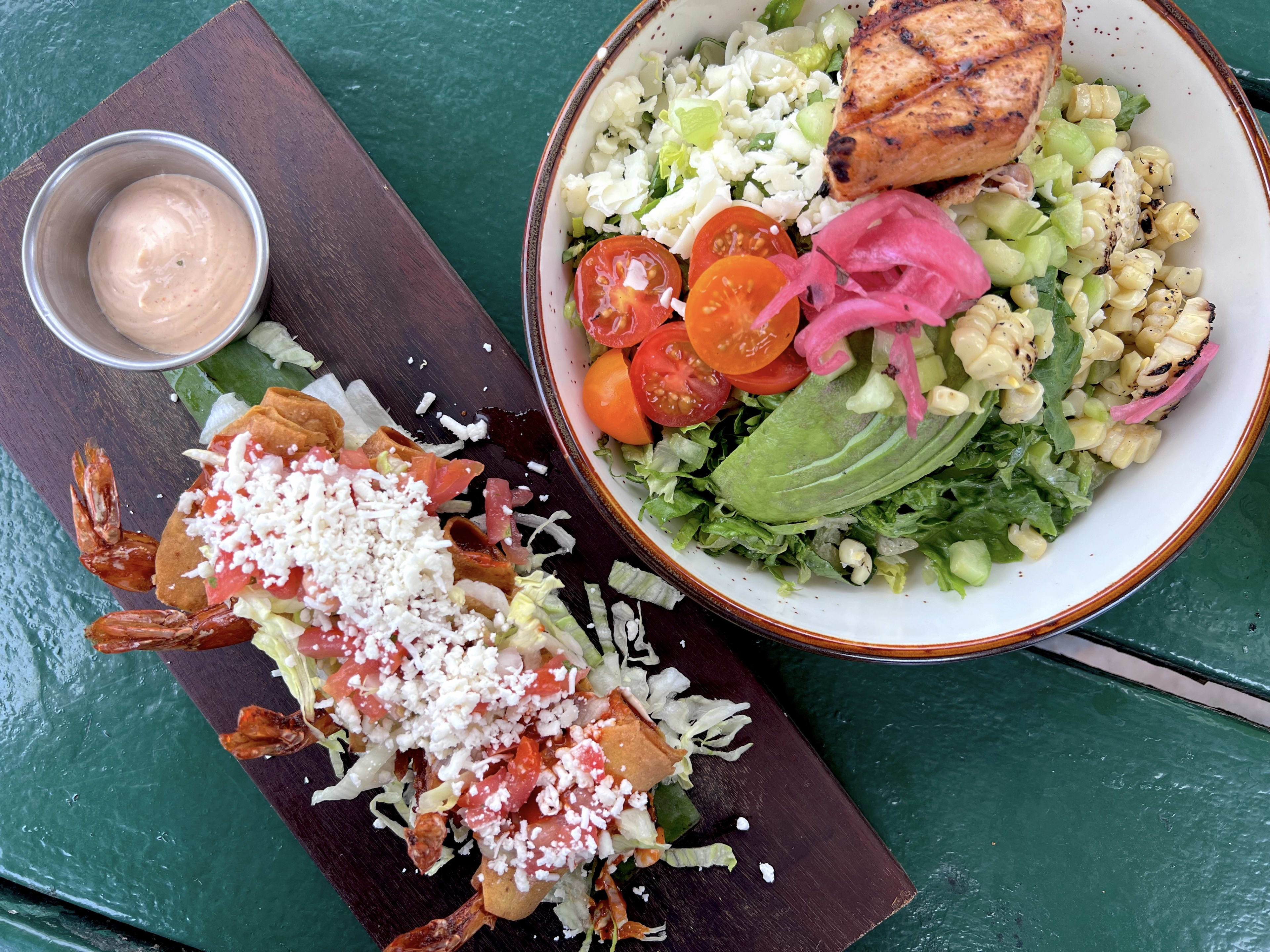 Shrimp taquitos and a salad bowl at Carmelita's