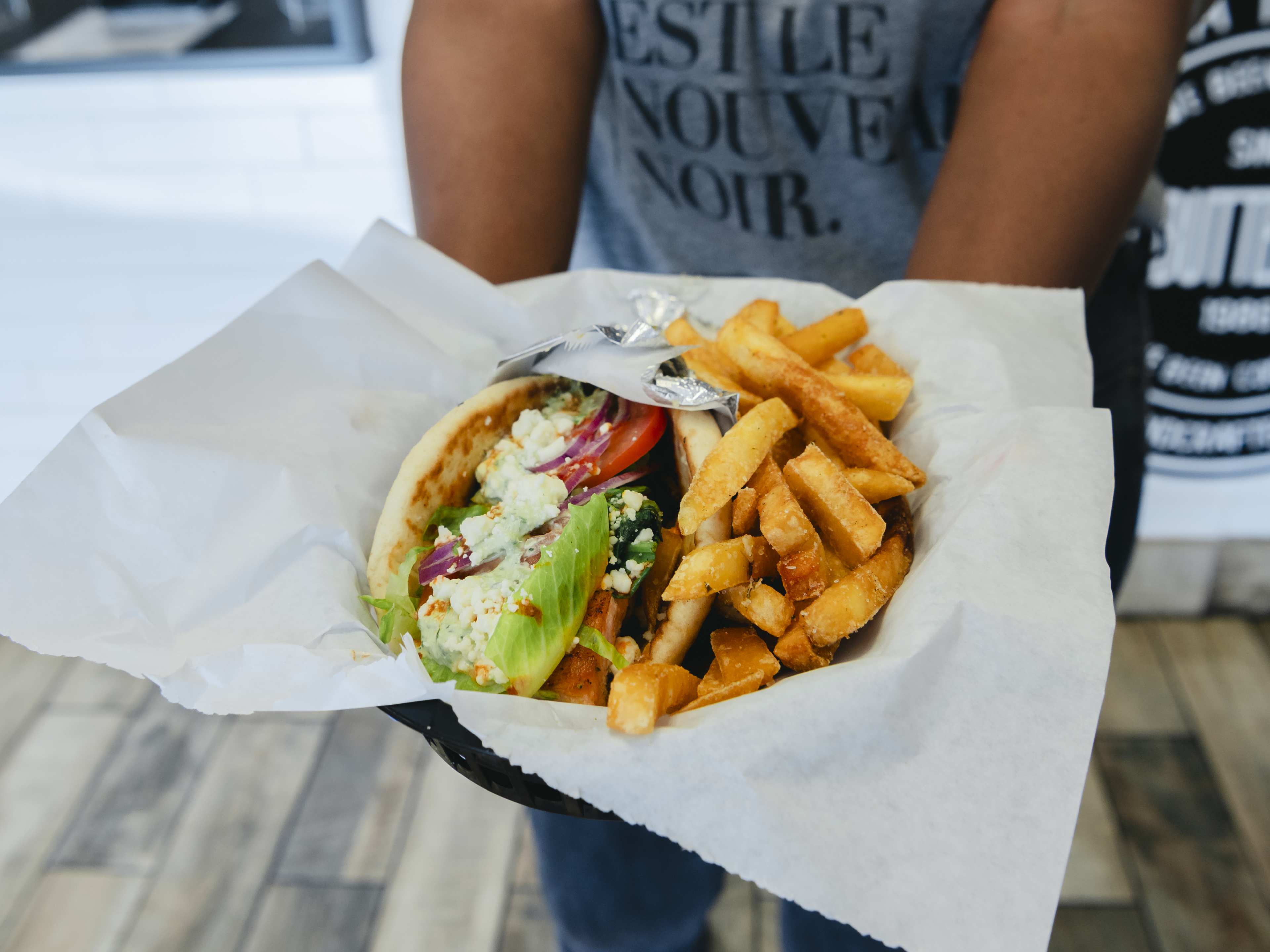 salmon pita with lettuce, tomato, and feta served with fries