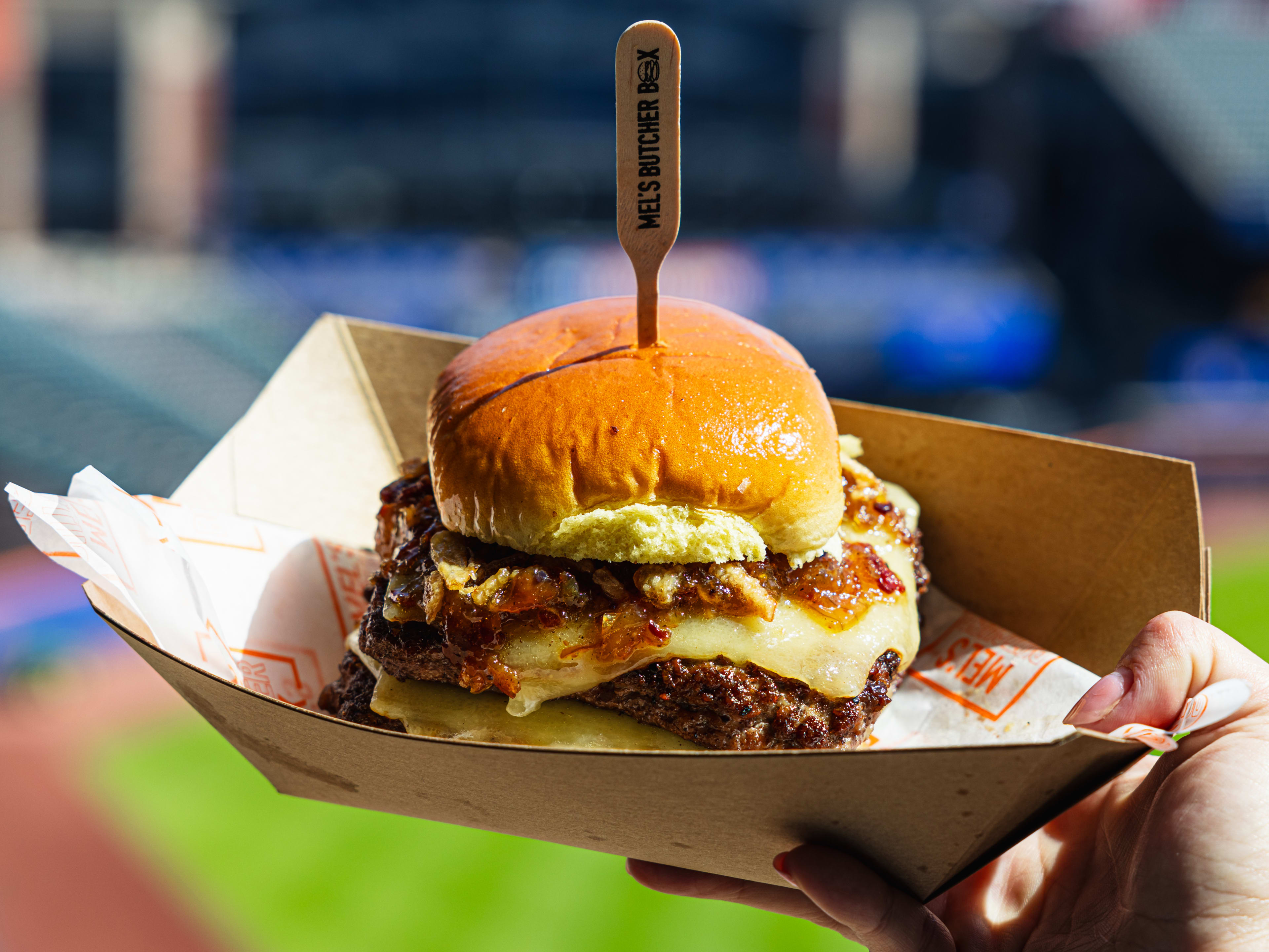 a cheeseburger with maple bourbon bacon jam and fried shallots