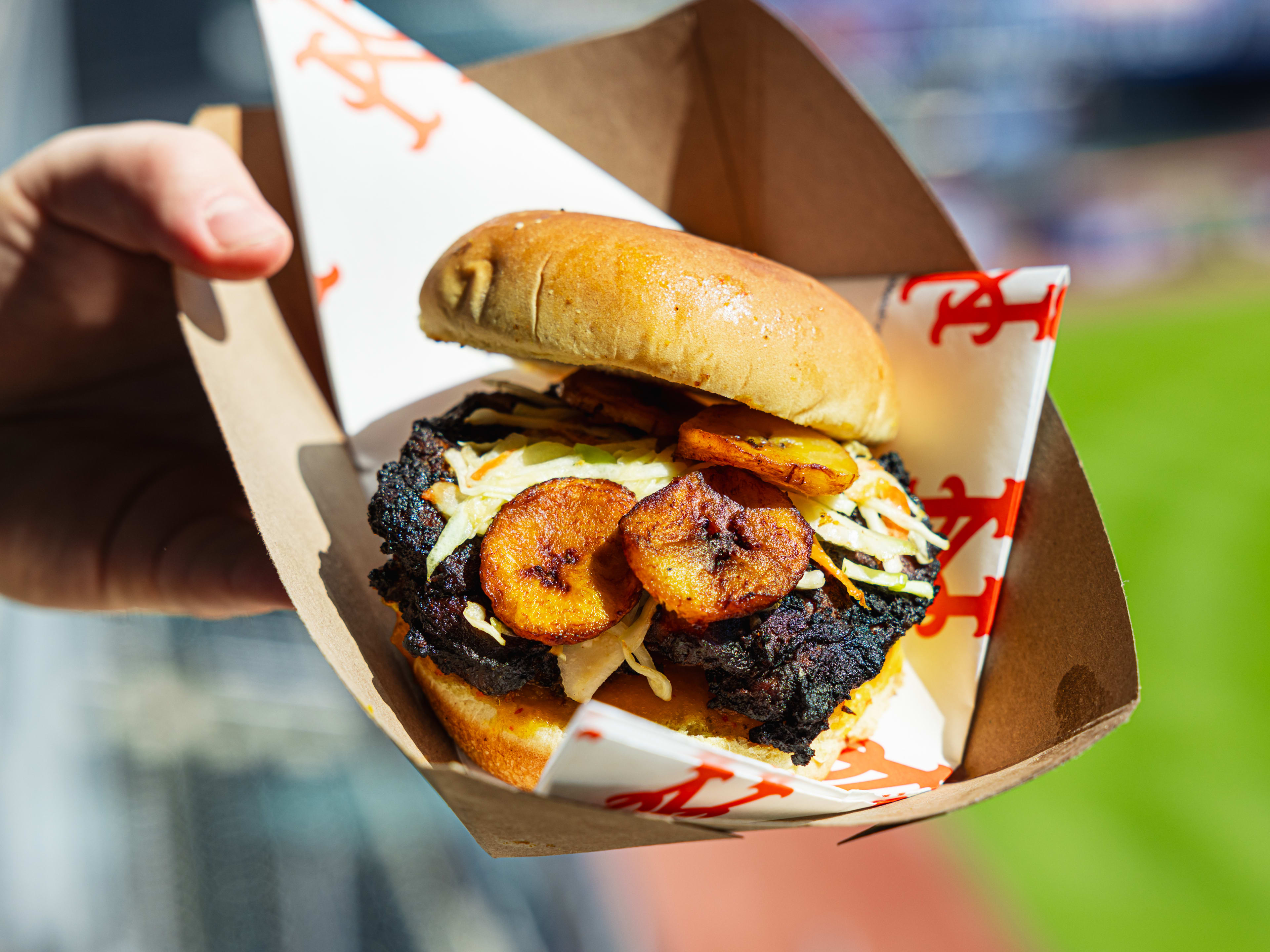 a jerk chicken sadnwich with plantains and pineapple slaw