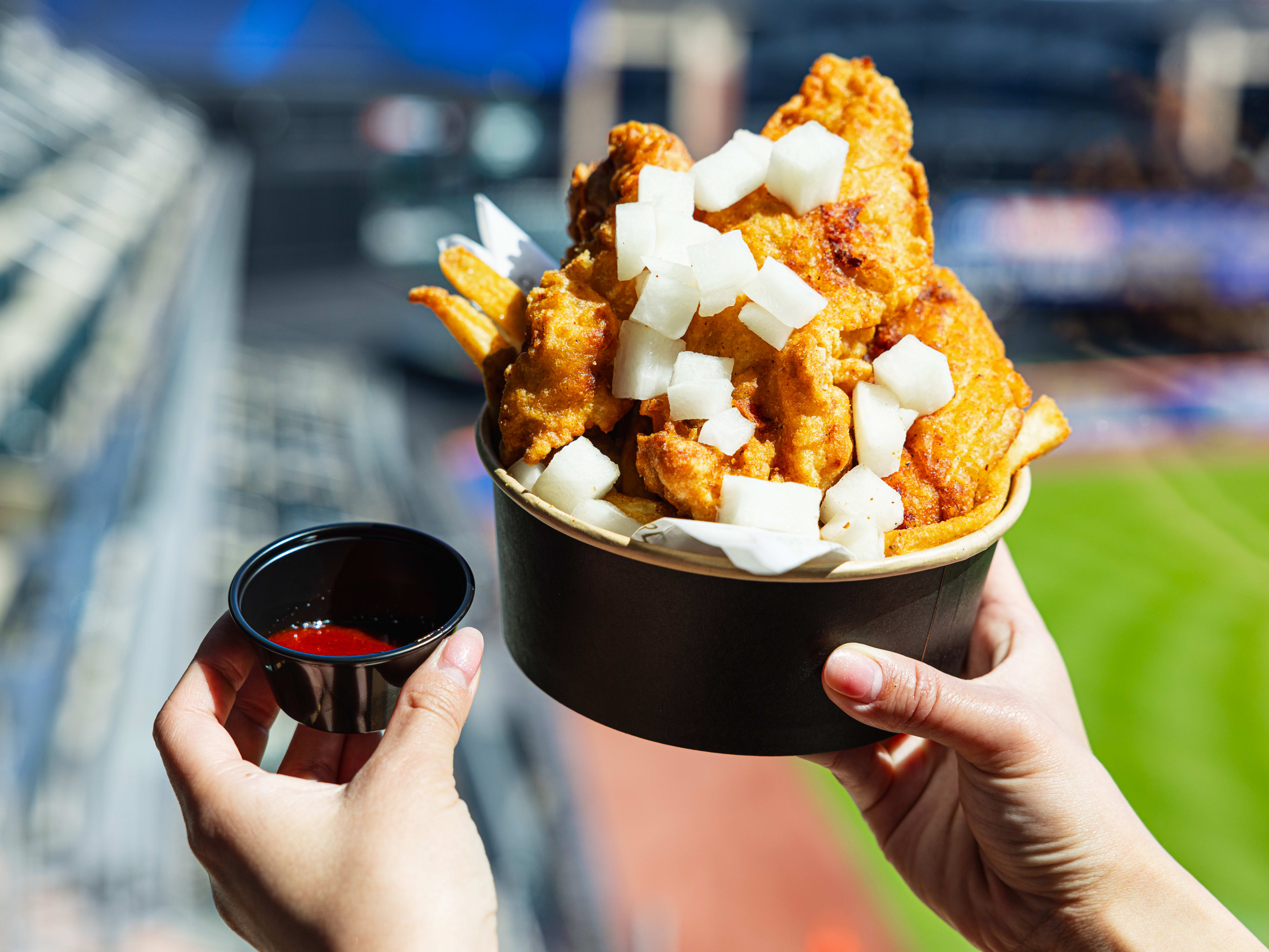 a bucket of korean fried chicken at citi field with pickled daikon radish
