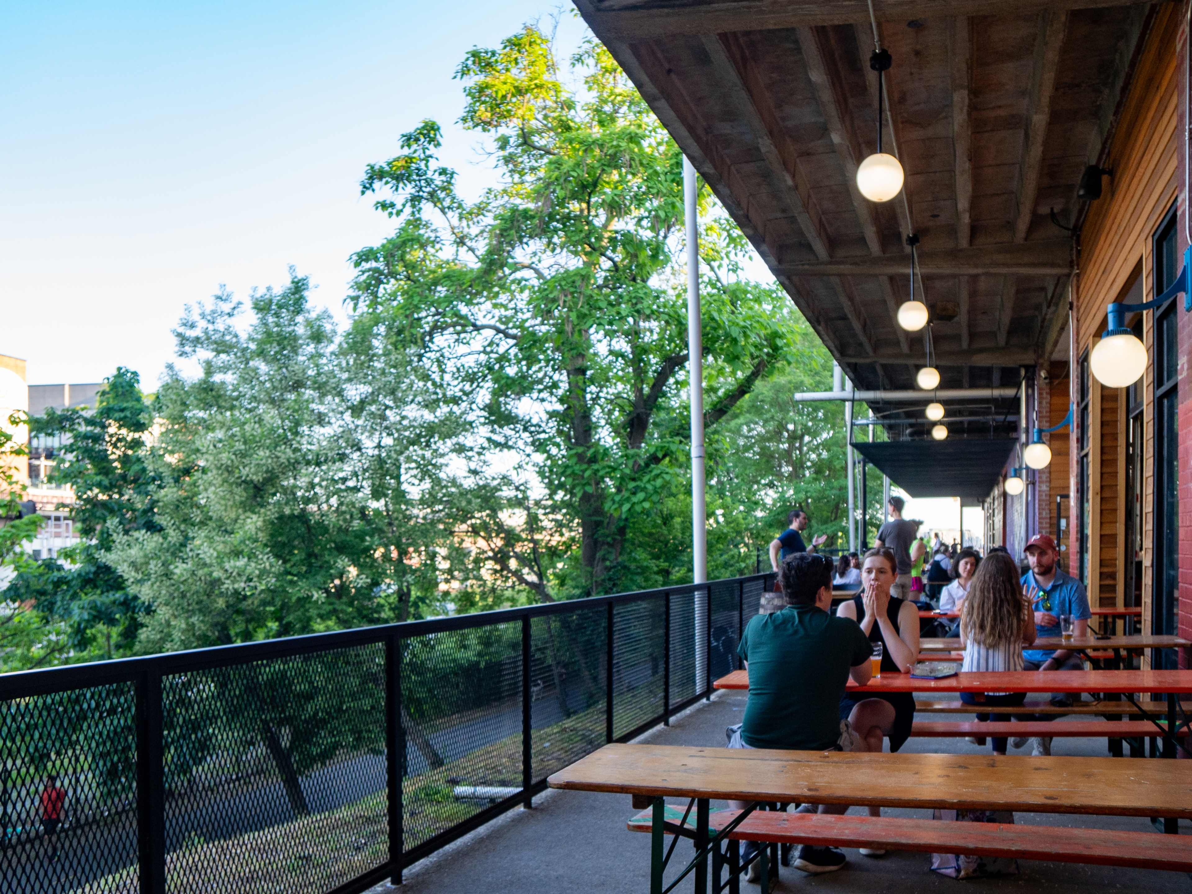 exterior patio of brewery overlooking tree lined street