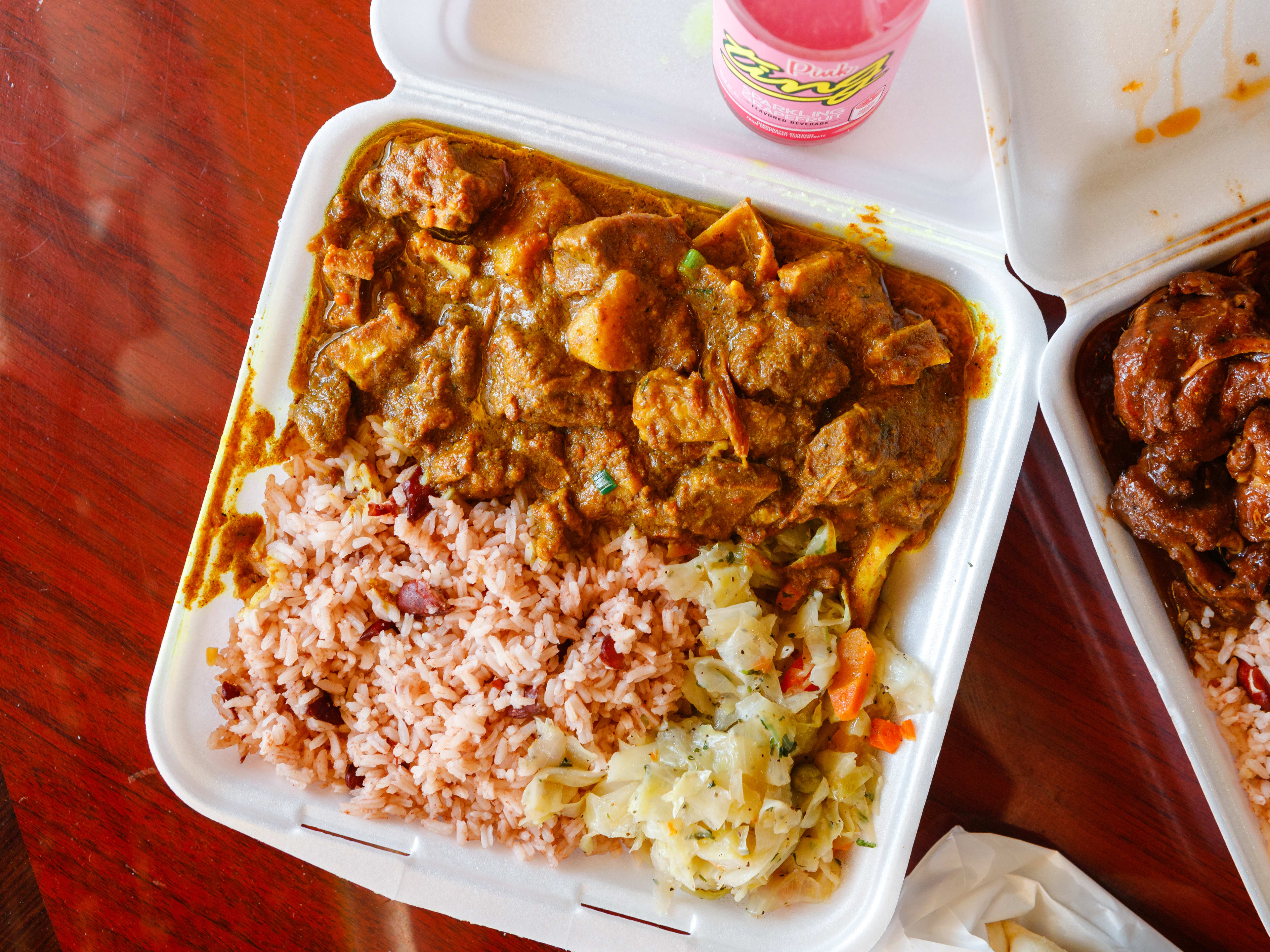 curry goat, rice and peas, cabbage, and plantains