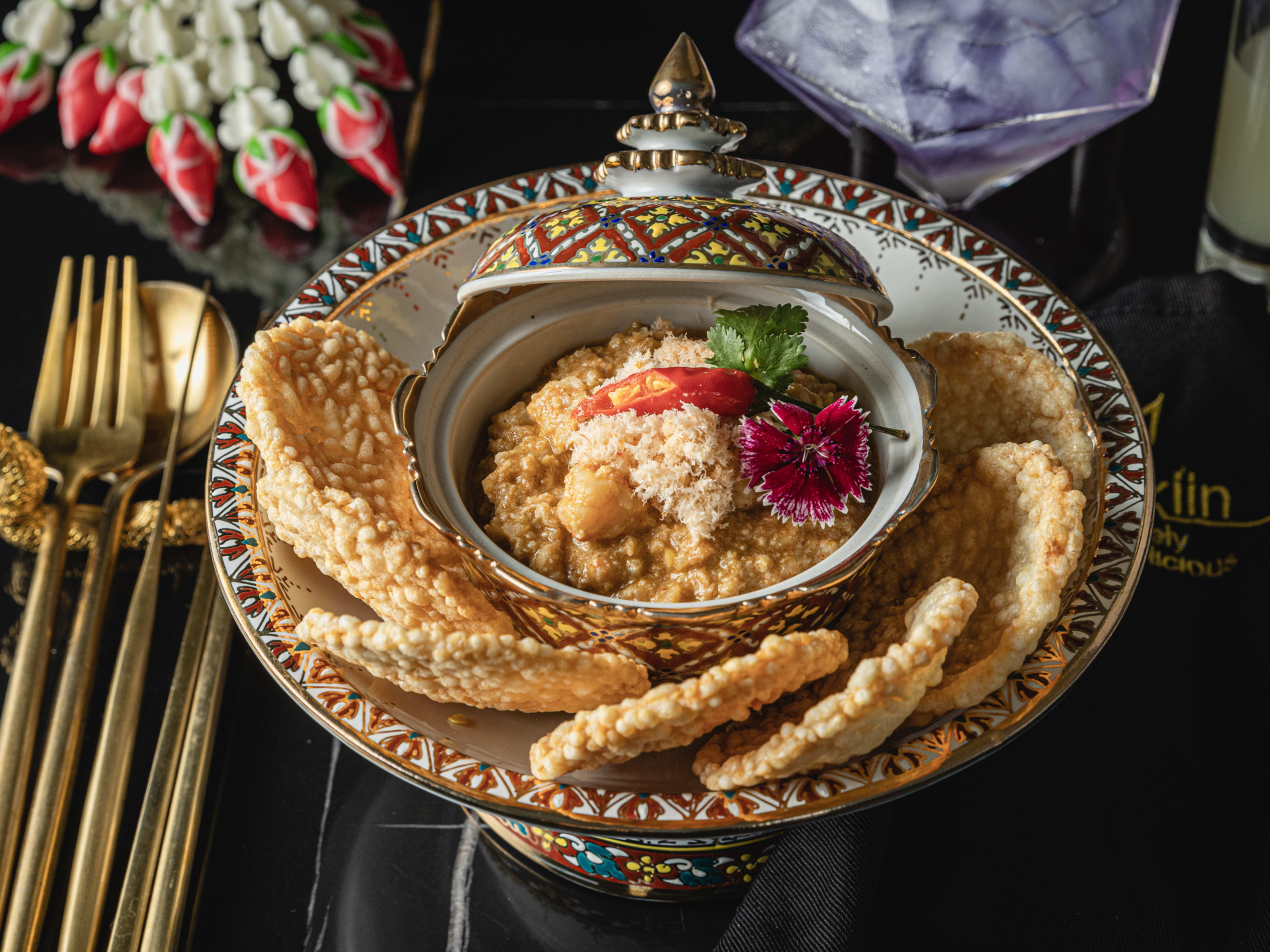 small bowl of coconut dip surrounded by circular rice cakes