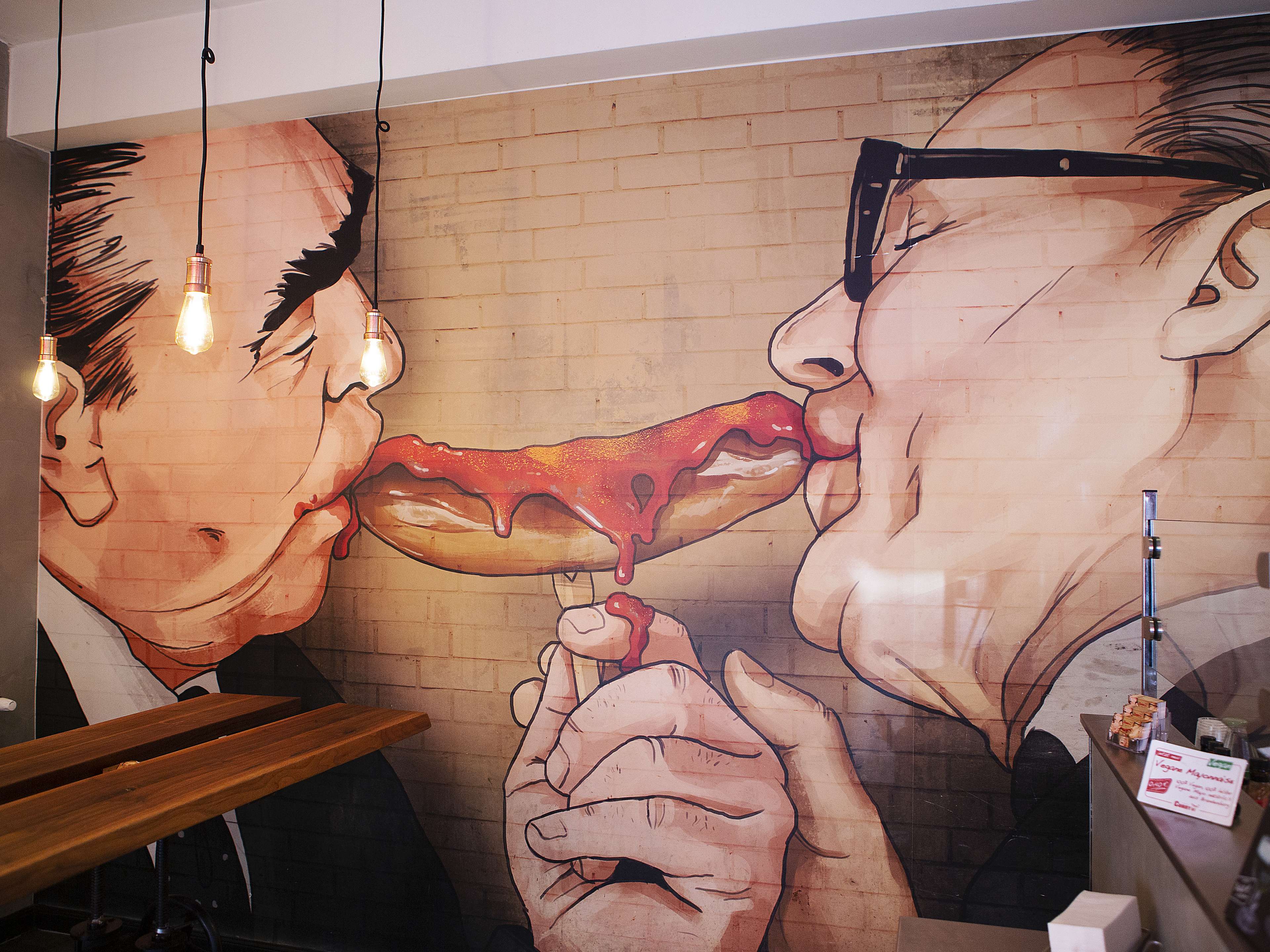 Mural of the Fraternal Kiss with a curry wurst at Curry 61